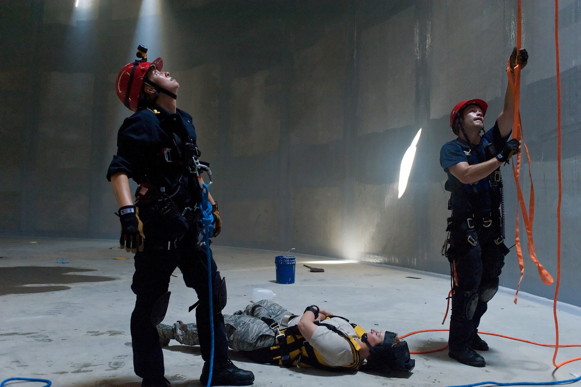 Two members of the Kent County Special Operations team make sure rescue lines are secure before attempting a rescue inside the new one million gallon water tank on Dover Air Force Base, Del., July 24, 2010. The 436th Civil Engineer Squadron Fire Department hosted a "confined space rescue" training and exercise at the CE compound. (U.S. Air Force photo by Roland Balik/Released)