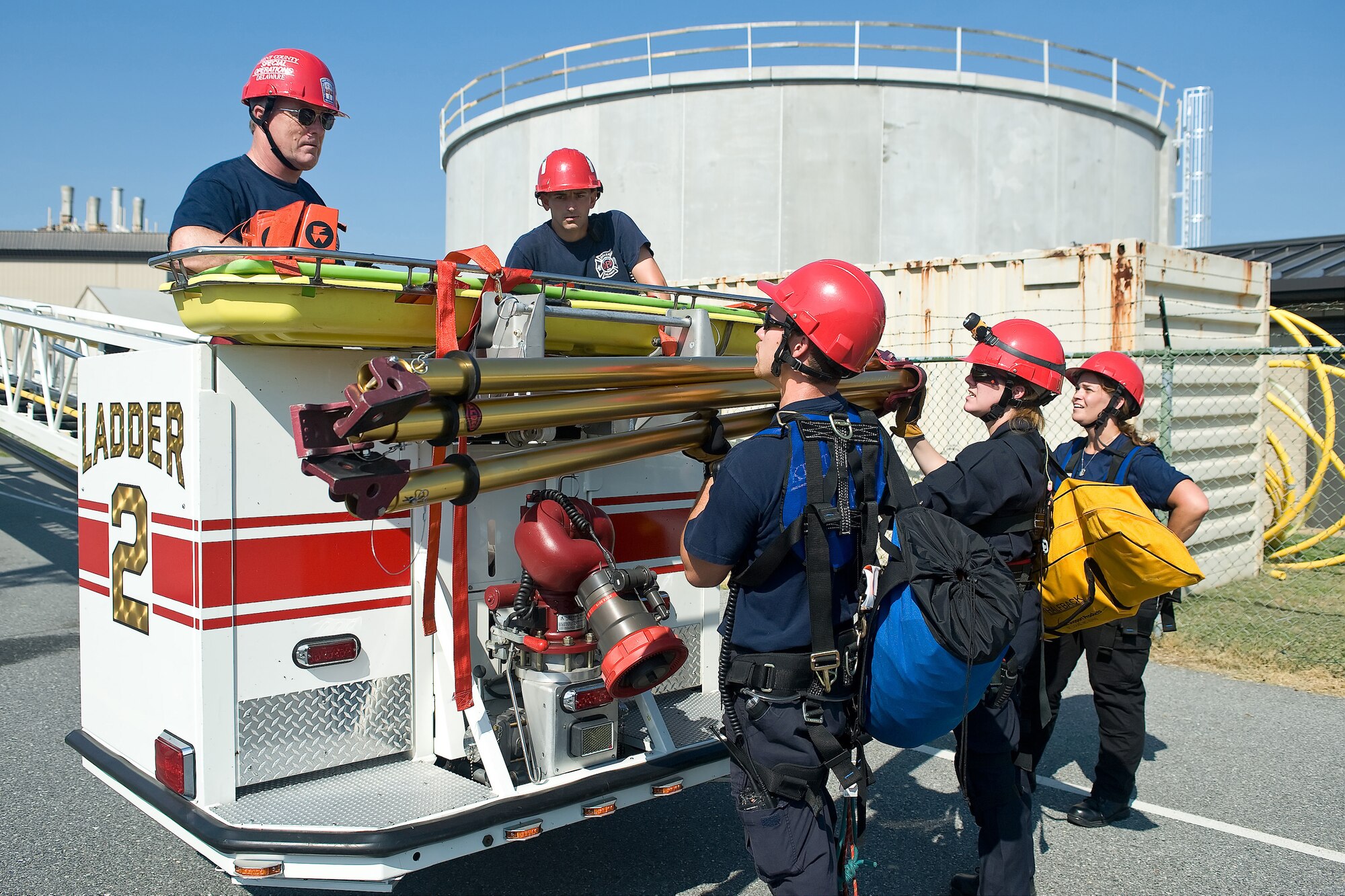 Members of the Kent County Special Operations team get their equipment ready outside the one million gallon water tank on Dover Air Force Base, Del., July 24, 2010. The 436th Civil Engineer Squadron Fire Department hosted a "confined space rescue" training and exercise at the CE compound. (U.S. Air Force photo by Roland Balik/Released)