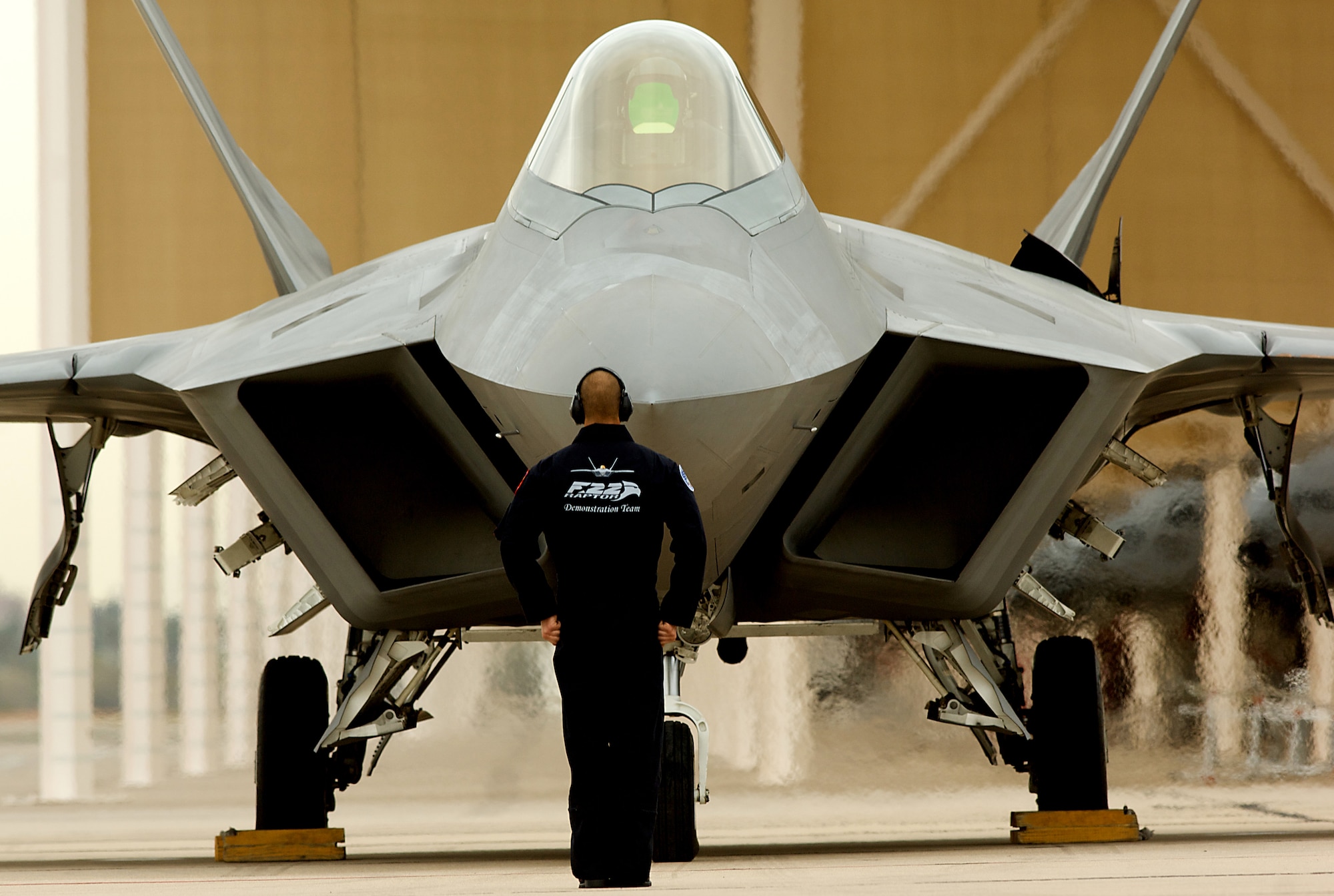 DAVIS-MONTHAN AIR FORCE BASE, Ariz. -- A crew chief for the F-22 Demonstration Team prepares Maj. David Skalicky for takeoff during the Heritage Flight Conference March 6. The Raptor is the world’s only operational fifth-generation fighter aircraft. The Heritage Flight Conference allows pilots to fine-tune their skills before the upcoming air show season begins. (U.S. Air Force photo/Staff Sgt. Samuel Rogers)