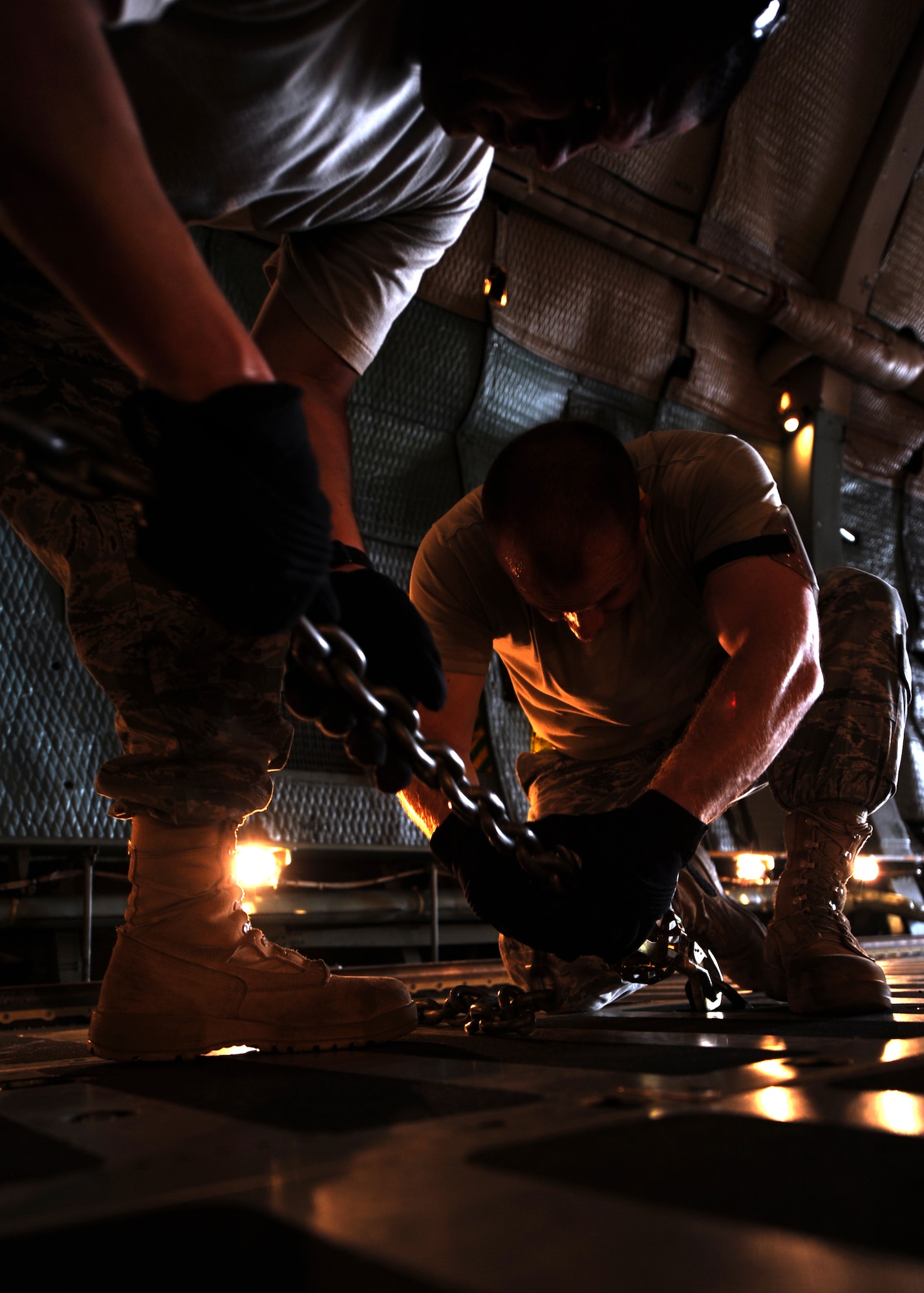 Staff Sgt. Kyle Wills, left, and Tech. Sgt. Daniel Haefner secure a V-2000NG well drilling system to the bed of a C-5 Galaxy cargo plane July 30, 2010, on Joint Base Charleston, S.C. Aerial porters, known as "port dawgs," carefully distribute cargo evenly throughout the aircraft ensuring the cargo does not move freely causing the aircraft's stability to falter during flight. Depending on the weight and size of the cargo, different tie-down configurations are used to secure the cargo. Sergeant Wills is an air transportation specialist in the Air Force Reserve with the 38th Aerial Port Squadron and Sergeant Haefner is an air transportation specialist with the 437th Aerial Port Squadron. (U.S. Air Force photo/Senior Airman Timothy Taylor)