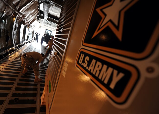 Airmen with the West Virginia Air National Guard and the 437th Aerial Port Squadron work to load and secure U.S. Army procured water drilling equipment July 30, 2010, on Joint Base Charleston, S.C. The Army contracted Laibe Corp to supply well drilling equipment for overseas operations allowing essential access to potable water in remote locations. (U.S. Air Force photo/Senior Airman Timothy Taylor)