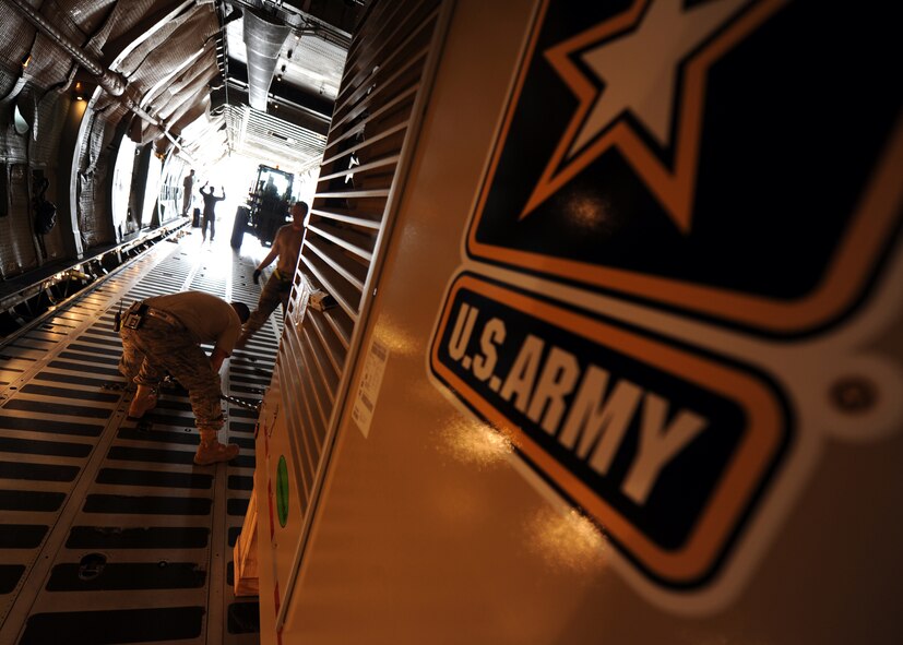 Airmen with the West Virginia Air National Guard and the 437th Aerial Port Squadron work to load and secure U.S. Army procured water drilling equipment July 30, 2010, on Joint Base Charleston, S.C. The Army contracted Laibe Corp to supply well drilling equipment for overseas operations allowing essential access to potable water in remote locations. (U.S. Air Force photo/Senior Airman Timothy Taylor)