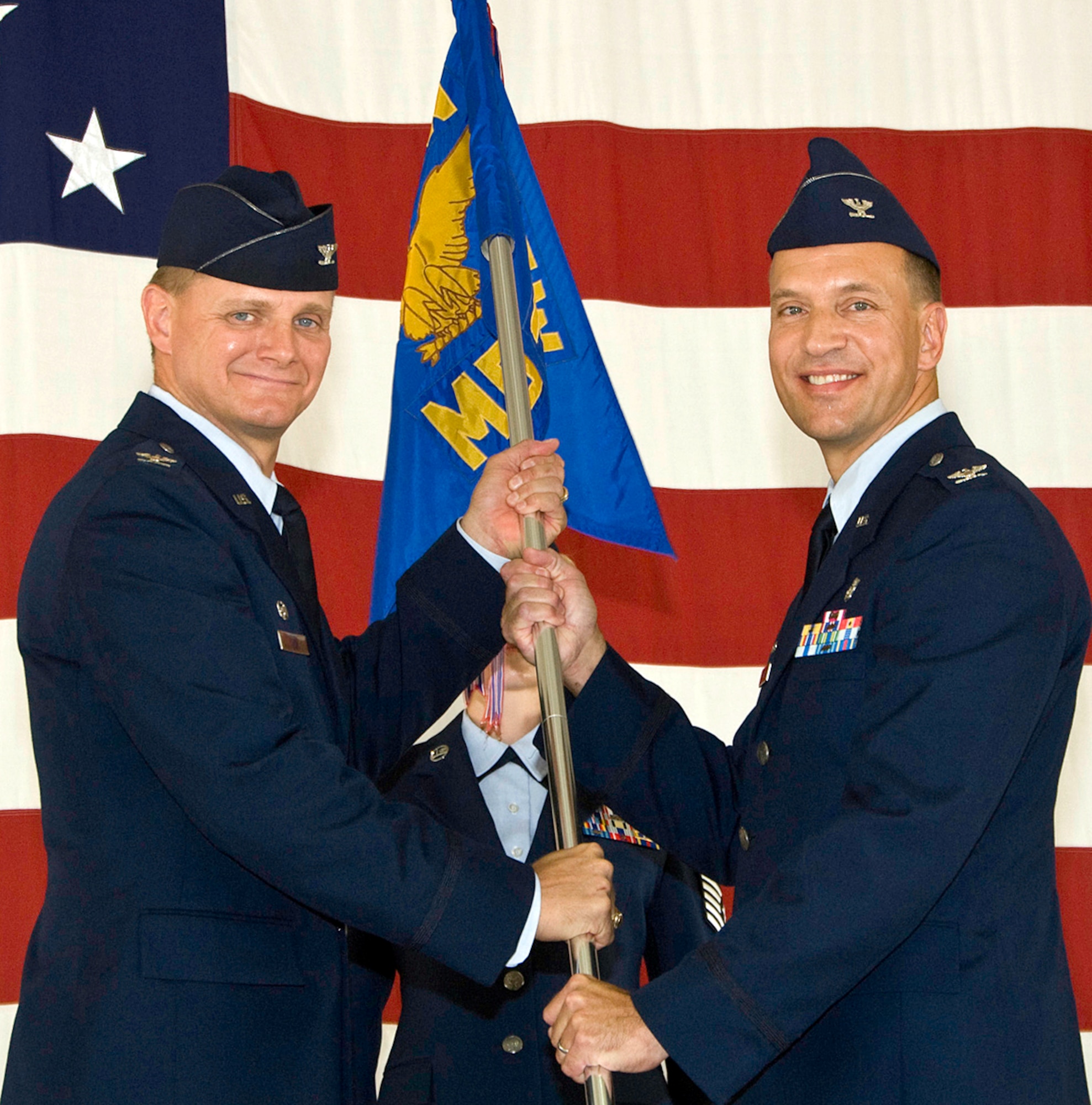 Col. Douglas Curry, right, accepts command of the 71st Medical Group from Col. Russ Mack, 71st Flying Training Wing commander, during a ceremony July 29 in Hangar 199. Colonel Curry comes to Vance from the 96th Dental Squadron at Eglin AFB, Fla. Col. Otha Solomon, the previous commander of the Medical Group, is retiring from the Air Force and moving to Alabama. (U.S. Air Force photo/ Terry Wasson)