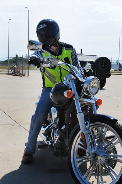 ELLSWORTH AIR FORCE BASE, S.D. -- Airman 1st Class James Mason, 28th Civil Engineer Squadron heating, ventilation and air-conditioning technician, checks his mirrors before backing up, Aug. 3.  When riding a motorcycle it's important to be aware of the surroundings, because in most motorcycle accidents the driver of the car does not see the cyclist. (U.S. Air Force photo/Airman 1st Class Anthony Sanchelli)