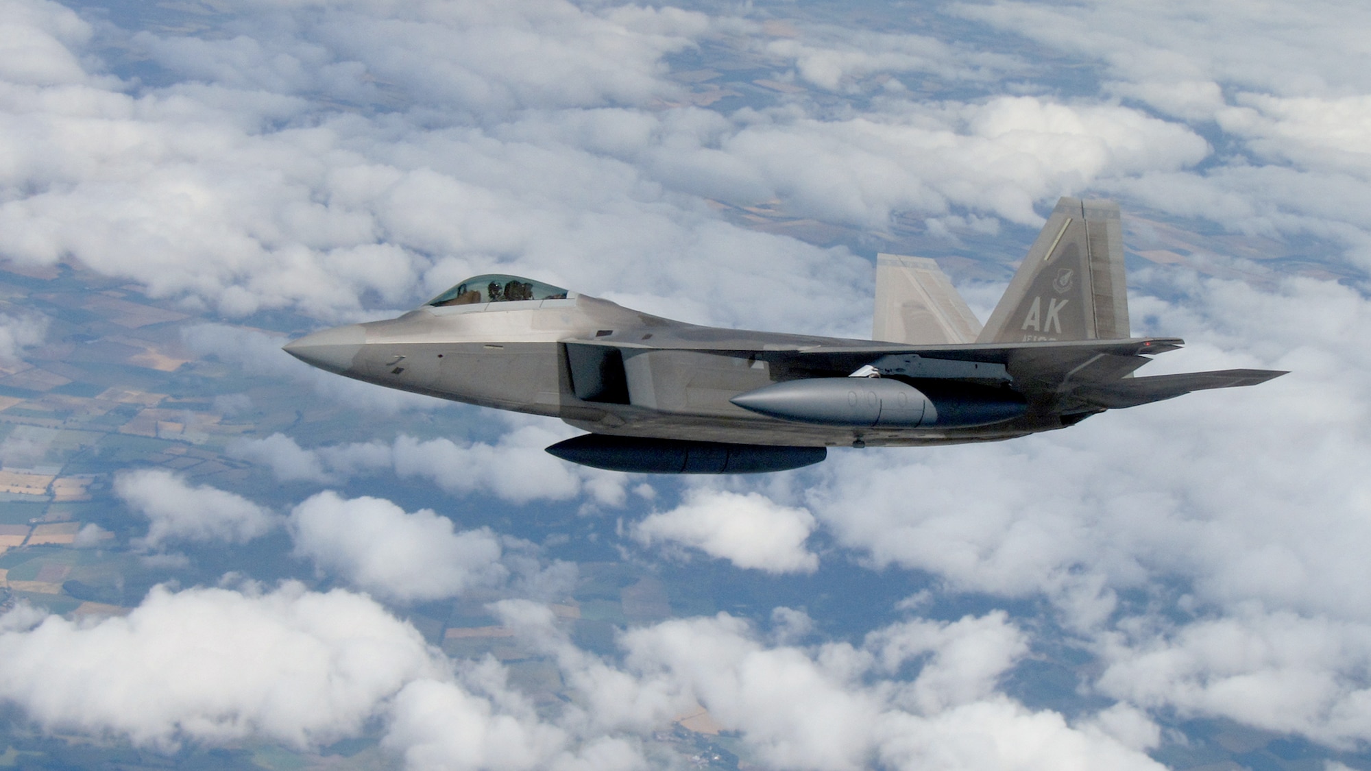 An F-22 Raptor from Elmendorf Air Force Base, Alaska, hangs off the wing of a KC-135 en route to the United States July 27, 2010. By sticking close to the tanker, the fighter could regularly top off its fuel tanks to ensure it had enough fuel to reach safety in the event it had to land unexpectedly. The tanker is assigned to the 100th Air Refueling Wing at Royal Air Force Mildenhall, England. (U.S. Air Force photo/Staff Sgt. Austin M. May)