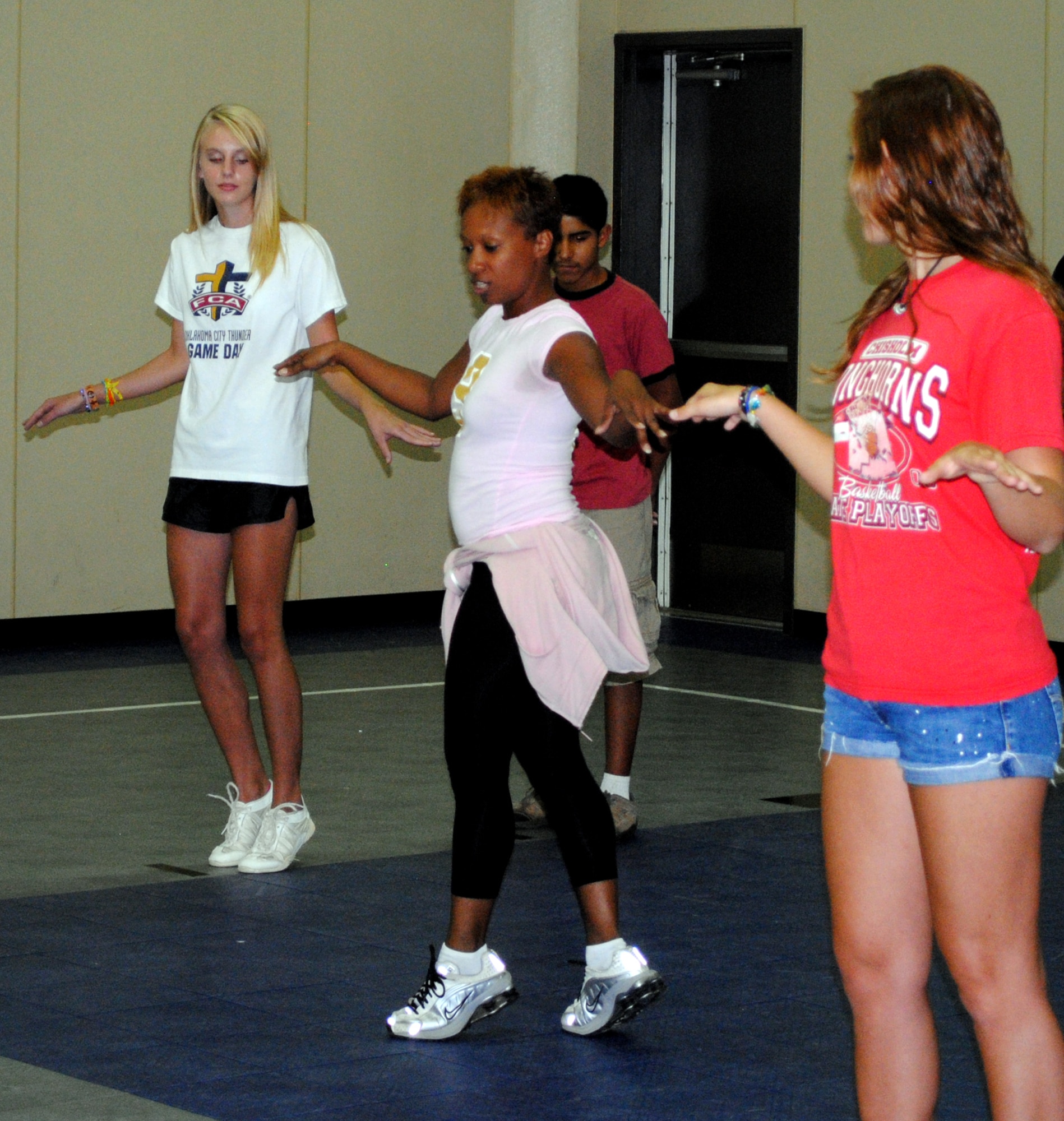 Mechel Miller, center, a dance instructor from I-Can Studios in Atlanta, Ga., takes Vance youth through a salsa routine during the Total Dance Experience Camp held in the Youth Center gym Aug. 2 through 6. Madison, left, daughter of Shannon Perry in the CSC Applied Technologies Human Resources office; Isac, behind instructor, son of Claudia Perez de Marshall in the CSC Parachute shop; and Alix, right, daughter of Patty Tyson in the Wing Quality Assurance Standardization and Evaluation office; will participate in the dance camp’s recital at 12:30 p.m., Friday, Aug. 6, in the Fitness Center gym. All Team Vance members are welcome to attend. (U.S. Air Force photo/ Jessica Gibson)
