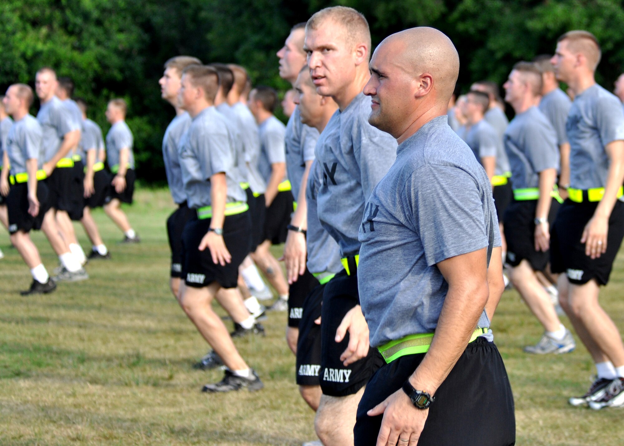 Lines of Army Explosive Ordnance Disposal students do jumping jacks during an afternoon physical training session at Eglin Air Force Base, Fla.  The 450 members of Bravo Company exercise four days a week after EOD classes end.  Combined with Alpha Company, there are approximately 750 Soldiers in stages of training at the 35-week Navy EOD course located at Eglin.  (U.S. Air Force photo/Tech Sgt. Cheryl Foster.)