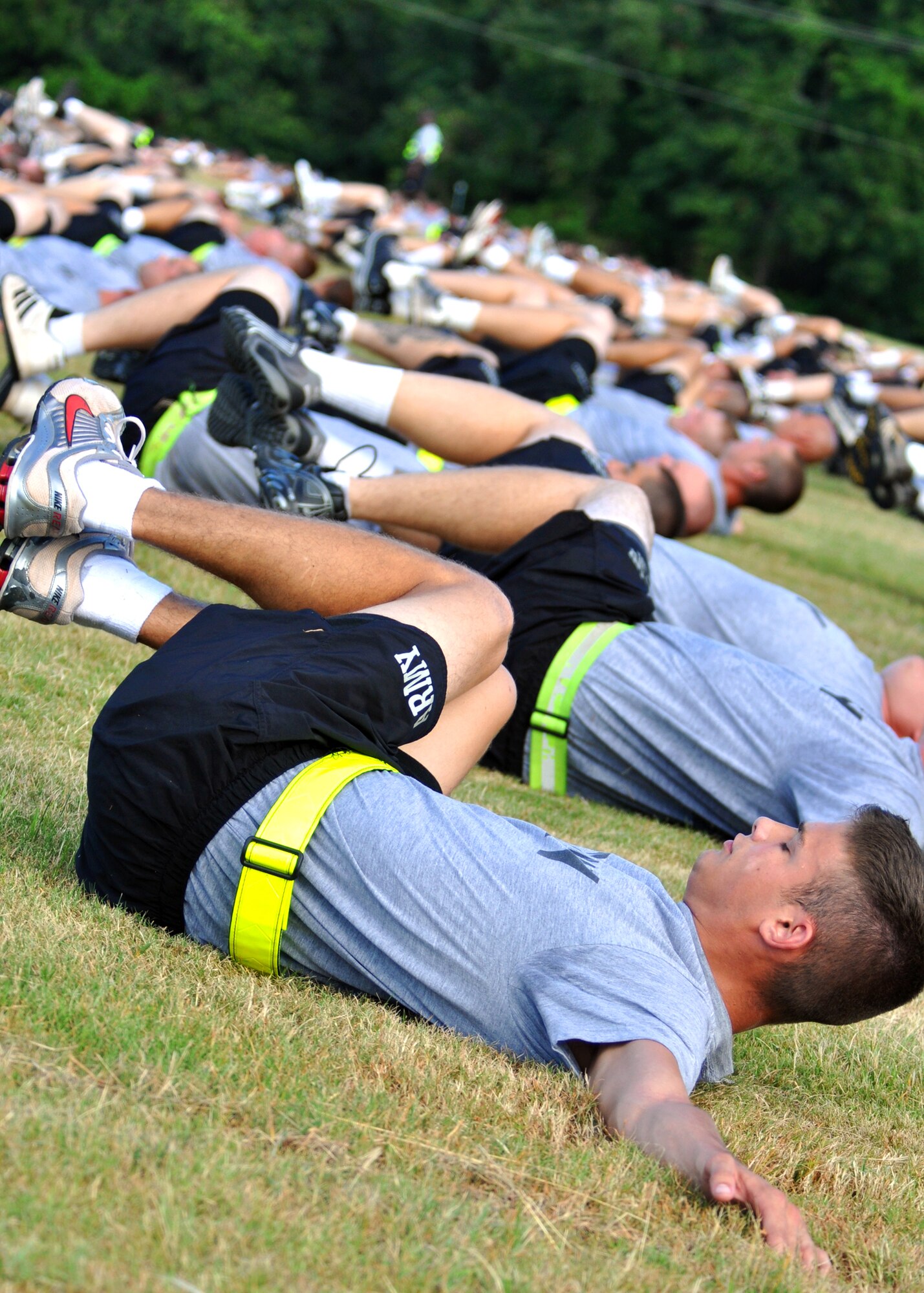 Rows of Army Explosive Ordnance Disposal students perform abdominal exercises during an afternoon physical training session at Eglin Air Force Base, Fla.  The 450 members of Bravo Company exercise four days a week after EOD classes end.  Combined with Alpha Company, there are approximately 750 Soldiers in stages of training at the 35-week Navy EOD course located at Eglin.  (U.S. Air Force photo/Tech Sgt. Cheryl Foster.)  