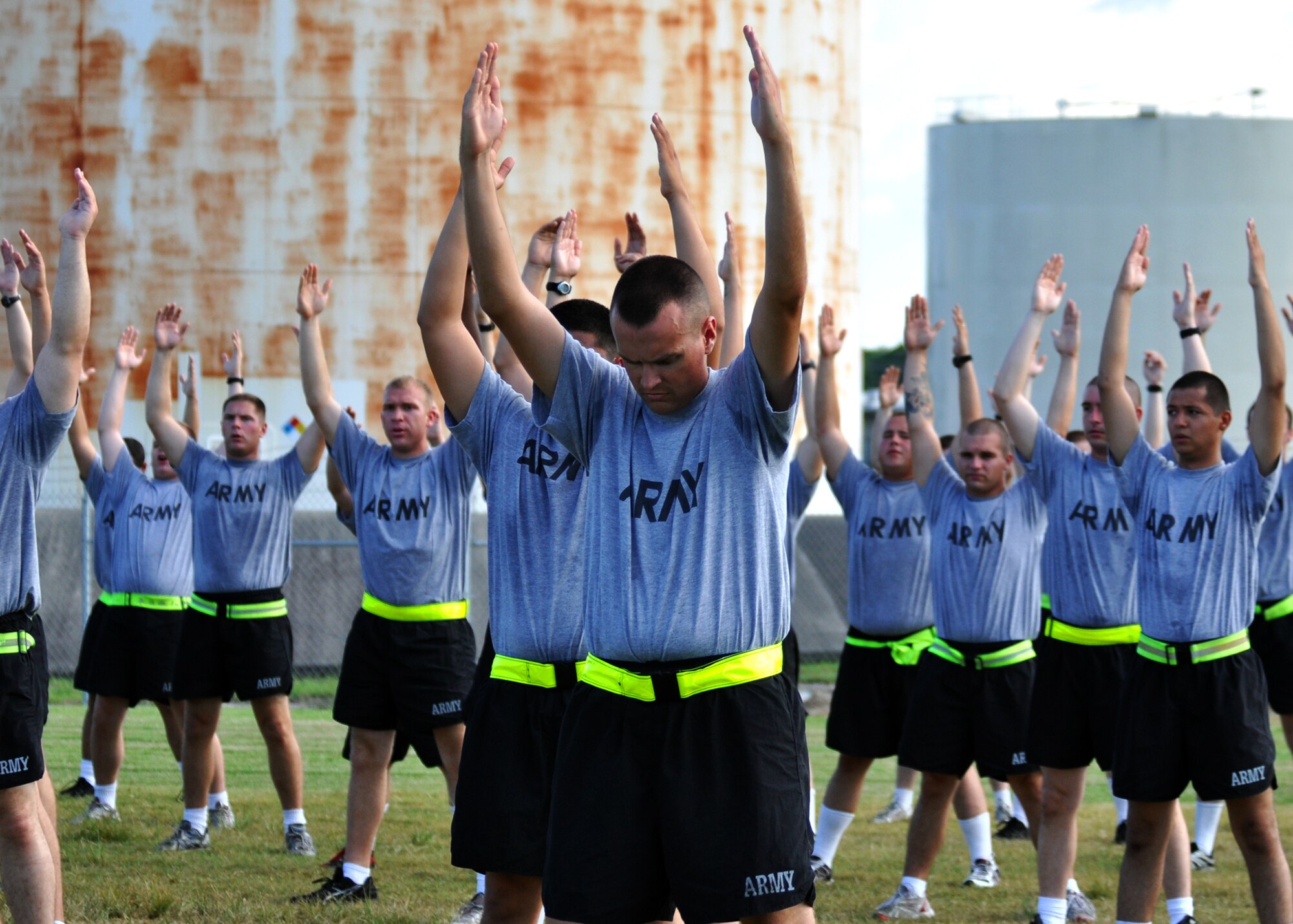 Army Explosive Ordnance Disposal students raise their arms during an afternoon physical training session at Eglin Air Force Base, Fla.  The 450 members of Bravo Company exercise four days a week after EOD classes end.  Combined with Alpha Company, there are approximately 750 Soldiers in stages of training at the 35-week Navy EOD course located at Eglin.  (U.S. Air Force photo/Tech Sgt. Cheryl Foster.)  