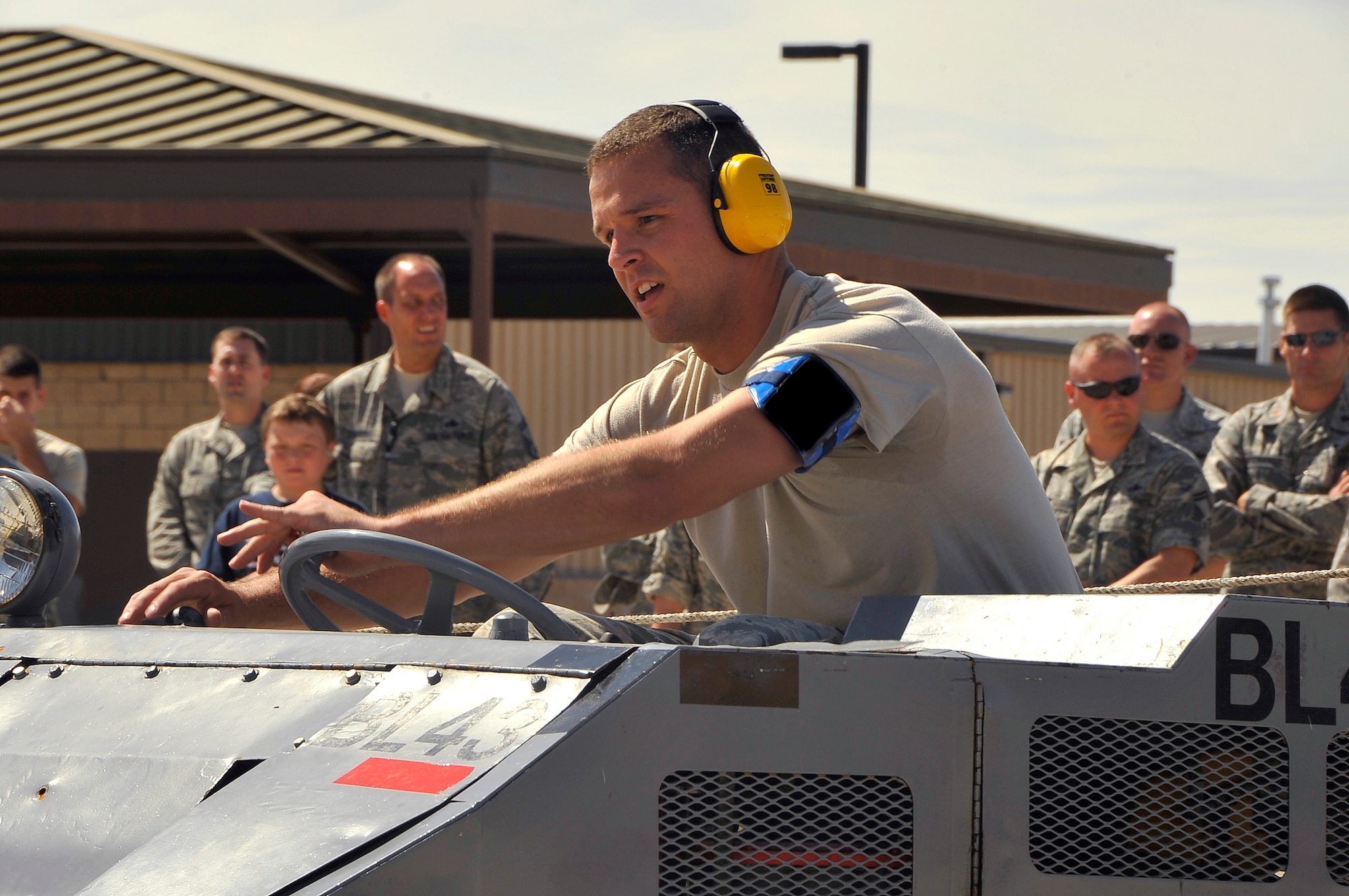 HOLLOMAN AIR FORCE BASE, N.M. -- Airman 1st Class Albert Lucas, 49th Aircraft Maintenance Squadron, watches his load crew chief for instructions on where to maneuver the MJ-1 Bomb lift Truck during the Weapons Load Crew Competition July 30, 2010. This friendly competition, held every quarter, requires crew members to load F-22 Raptors and MQ-9 Reapers with munitions within 30 minutes. Winners from each crew get plaques as well as a traveling trophy. (U.S. Air Force photo by Senior Airman Veronica Stamps/ Released)