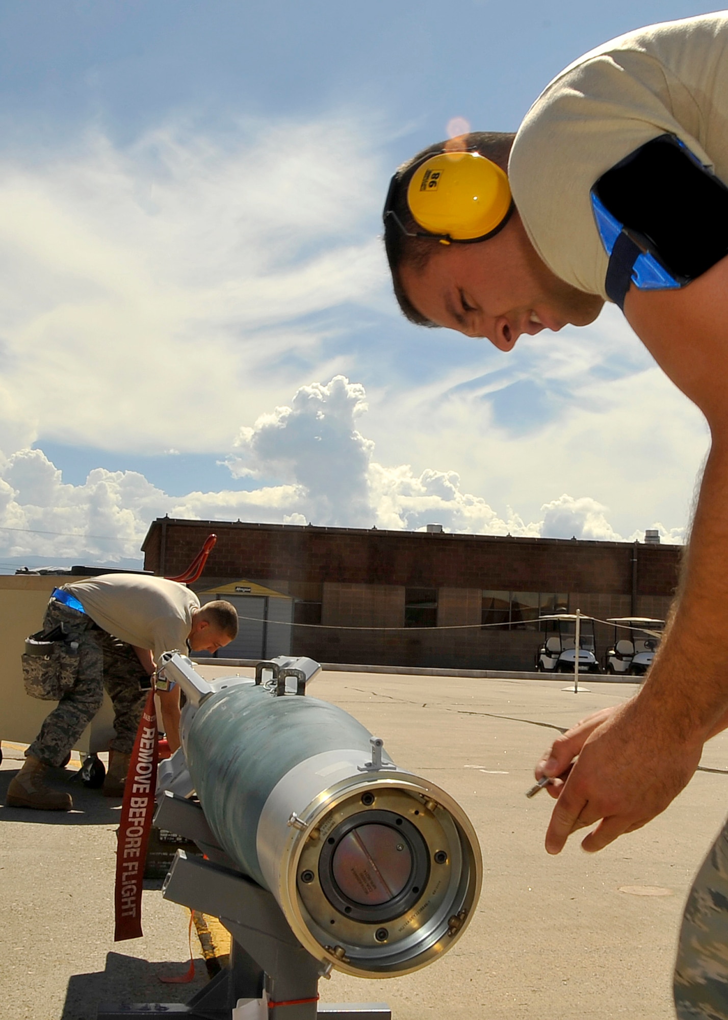 HOLLOMAN AIR FORCE BASE, N.M. -- Staff Sgt. Tylor Kearney and Airman 1st Class Albert Lucas, both from the 49th Aircraft Maintenance Squadron, check the Guided Bomb Unit 12 for serviceability to verify that the munition is configured properly during the Weapons Load Crew Competition July 30, 2010. This friendly competition, held every quarter, requires crew members to load F-22 Raptors and MQ-9 Reapers with munitions within 30 minutes. Winners from each crew get plaques as well as a traveling trophy. (U.S. Air Force photo by Senior Airman Veronica Stamps/ Released)