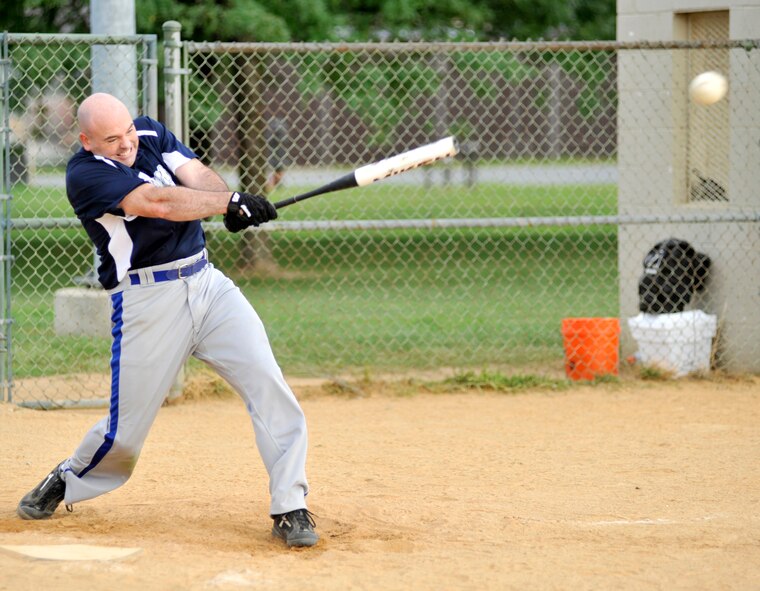 Joe Riff, of the 436th Communications Squadron, rips a single against the 436th Comptroller Squadron during a National League softball game at the base softball field on Dover Air Force Base, Del., Aug. 3, 2010. Despite Riff going 3-for-3 from the plate, COMM fell to CPTS 14-7. (U.S. Air Force photo by Tech. Sgt. Chuck Walker/Released)