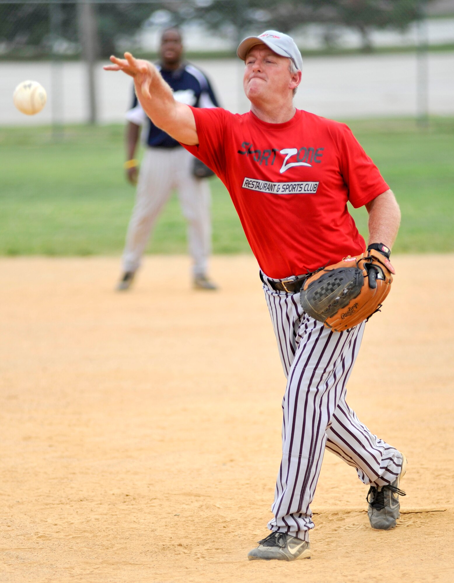 Mike Morris, 436th Communications Squadron pitcher, tosses a pitch during a National League softball game against the 436th Comptroller Squadron at the base softball field on Dover Air Force Base, Del., Aug. 3, 2010. CPTS defeated COMM 14-7. (U.S. Air Force photo by Tech. Sgt. Chuck Walker/Released)