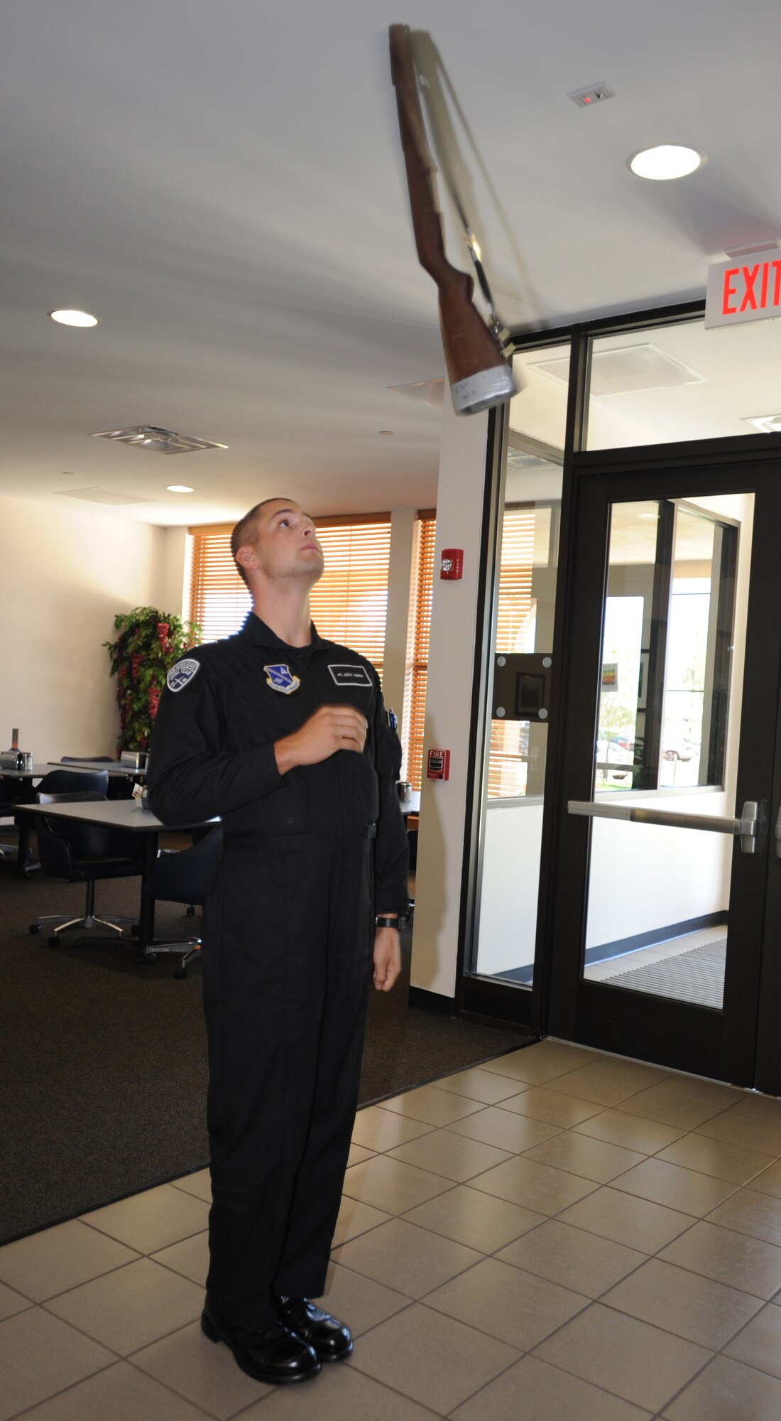 U.S. Air Force Airman 1st Class Justin Murray, United States Air Force Honor Guard Drill Team, demonstrates movements learned during Honor Guard training to Airman at the Pecos Trail Dining Facility, Cannon Air Force Base, N.M. Aug. 3, 2010. The team visited to entertain and recruit; about 80-85 percent of their manning comes from Basic Military Training, the rest from active duty members. (U.S. Air Force photo by Airman 1st Class Maynelinne De La Cruz) 