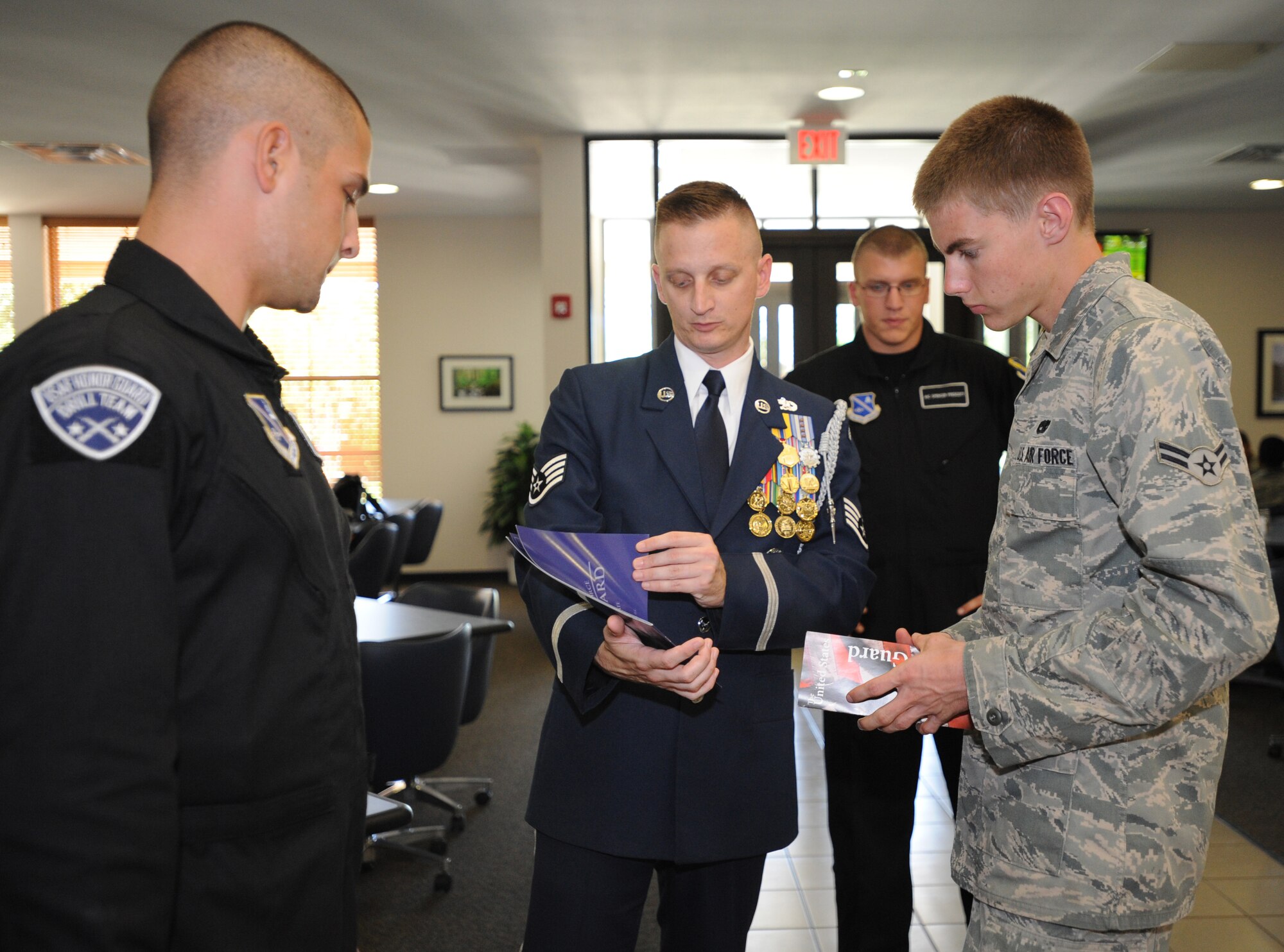U.S. Air Force Staff Sgt. Arron Schultz, United States Air Force Honor Guard Drill Team, explains the benefits of joining the Honor Guard team to U.S. Air Force Airman 1st Class Christopher Trevino, 73rd Aircraft Maintenance Unit Aug 3, 2010. The team visited to entertain and recruit; about 80-85 percent of their manning comes from Basic Military Training, the rest from active duty members. (U.S. Air Force photo by Airman 1st Class Maynelinne De La Cruz) 