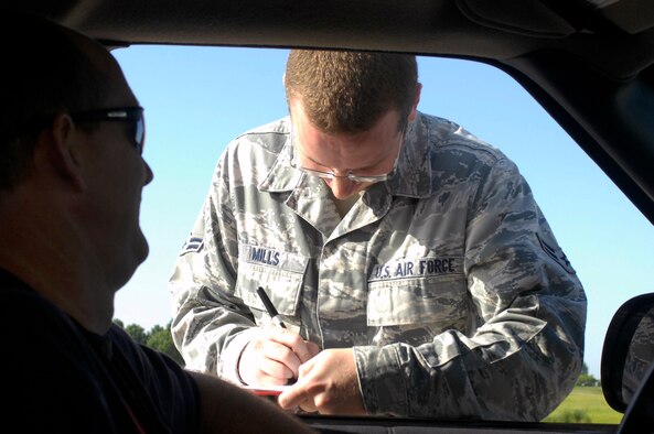WHITEMAN AIR FORCE BASE, Mo. - Airman 1st Class Brandon Mills, 509th Operations Support Squadron airfield management, checks an individual's flightline driver's competency card Aug. 4 during a random inspection. Airfield management manages the Airfield Driving Program for the 509th Bomb Wing. (U.S. Air Force photo/Senior Airman Jason Barebo)