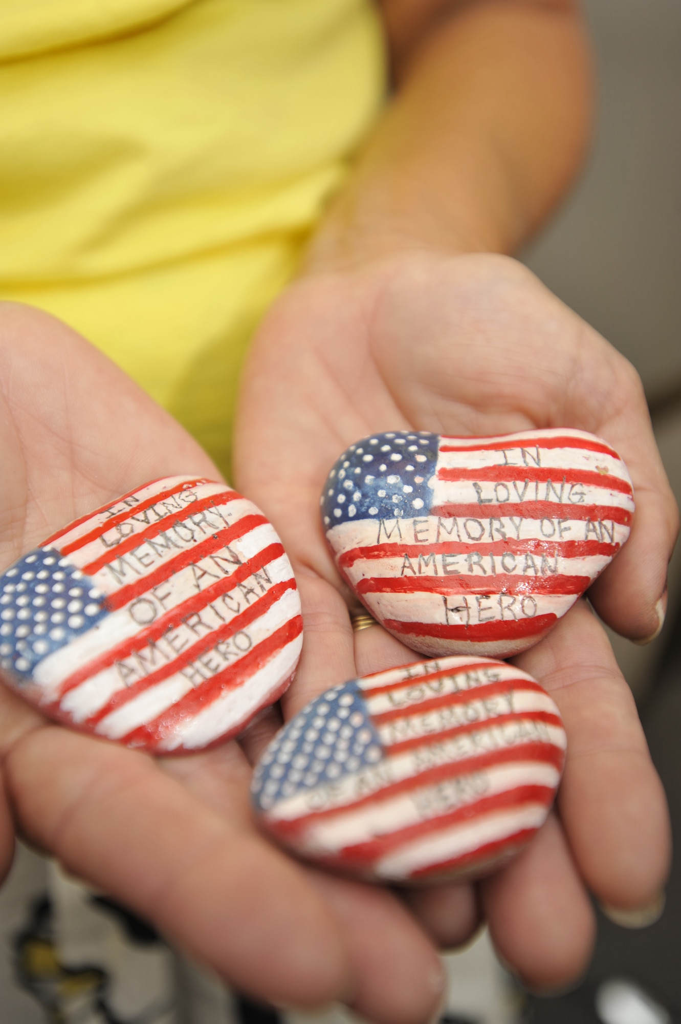 Holly Lindquist holds comfort stones she?s made engraved with, ?In Loving Memory of An American Hero,? at the 436th Airlift Wing Headquarters building on Dover Air Force Base, Del., July 29, 2010. Ms. Lindquist believes the stones resemble a part of the gravestone, and it is a way of bringing comfort to the mourning and remembrance of the deceased. (U.S. Air Force photo by Tech. Sgt. Chuck Walker/Released)
