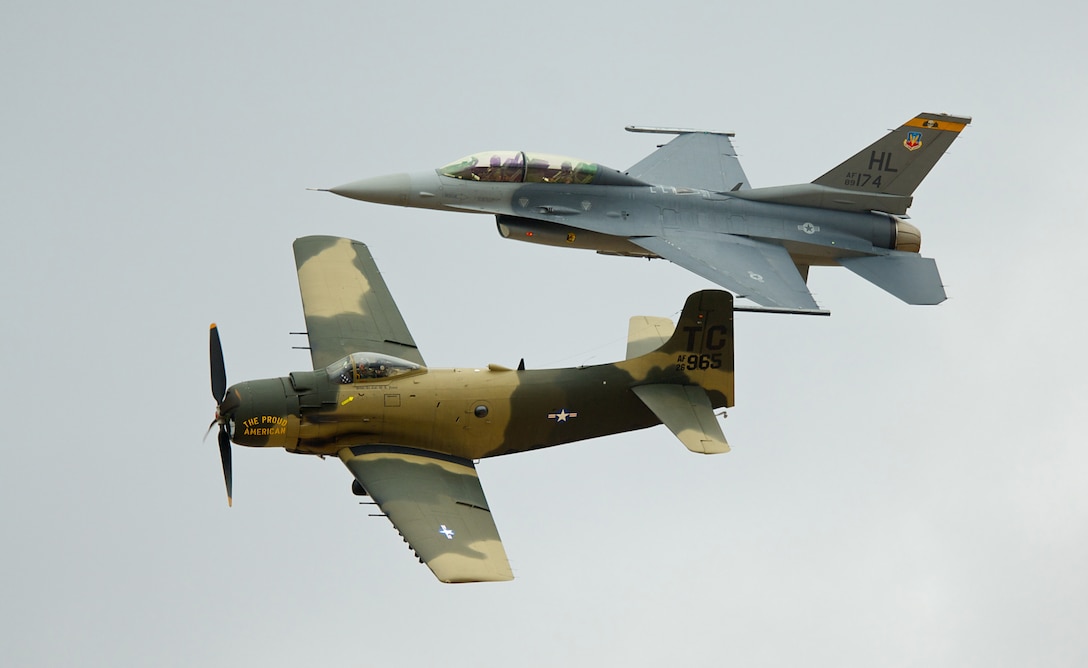 DAVIS-MONTHAN AIR FORCE BASE, Ariz. -- An F-16 Fighting Falcon (top) and A-1 Skyraider fly in formation during the Heritage Flight Conference March 6. Pilots of old and new aircraft come to the conference every year to practice demonstration flights together before the start of the air show season. (U.S. Air Force photo/Staff Sgt. Samuel Rogers)