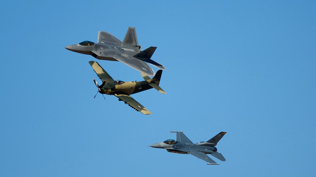 DAVIS-MONTHAN AIR FORCE BASE, Ariz. -- An F-22 Raptor (top), A-1 Skyraider (middle) and F-16 Fighting Falcon fly in formation during the Heritage Flight Conference March 7. Pilots of old and new aircraft come to the conference every year, to practice demonstration flights together before the start of the air show season. (U.S. Air Force photo/Staff Sgt. Samuel Rogers)