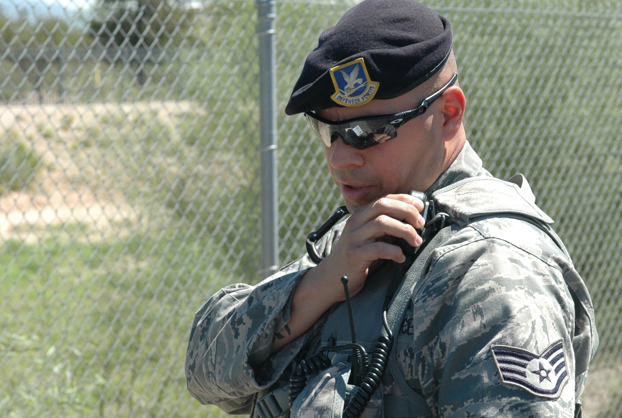 Staff Sgt. Abraham Pena, security forces craftsman, radios information on a traffic violator to the security dispatcher. Sergeant Pena returned to active duty with the Wing in mid-July after serving nearly six months in Iraq. 