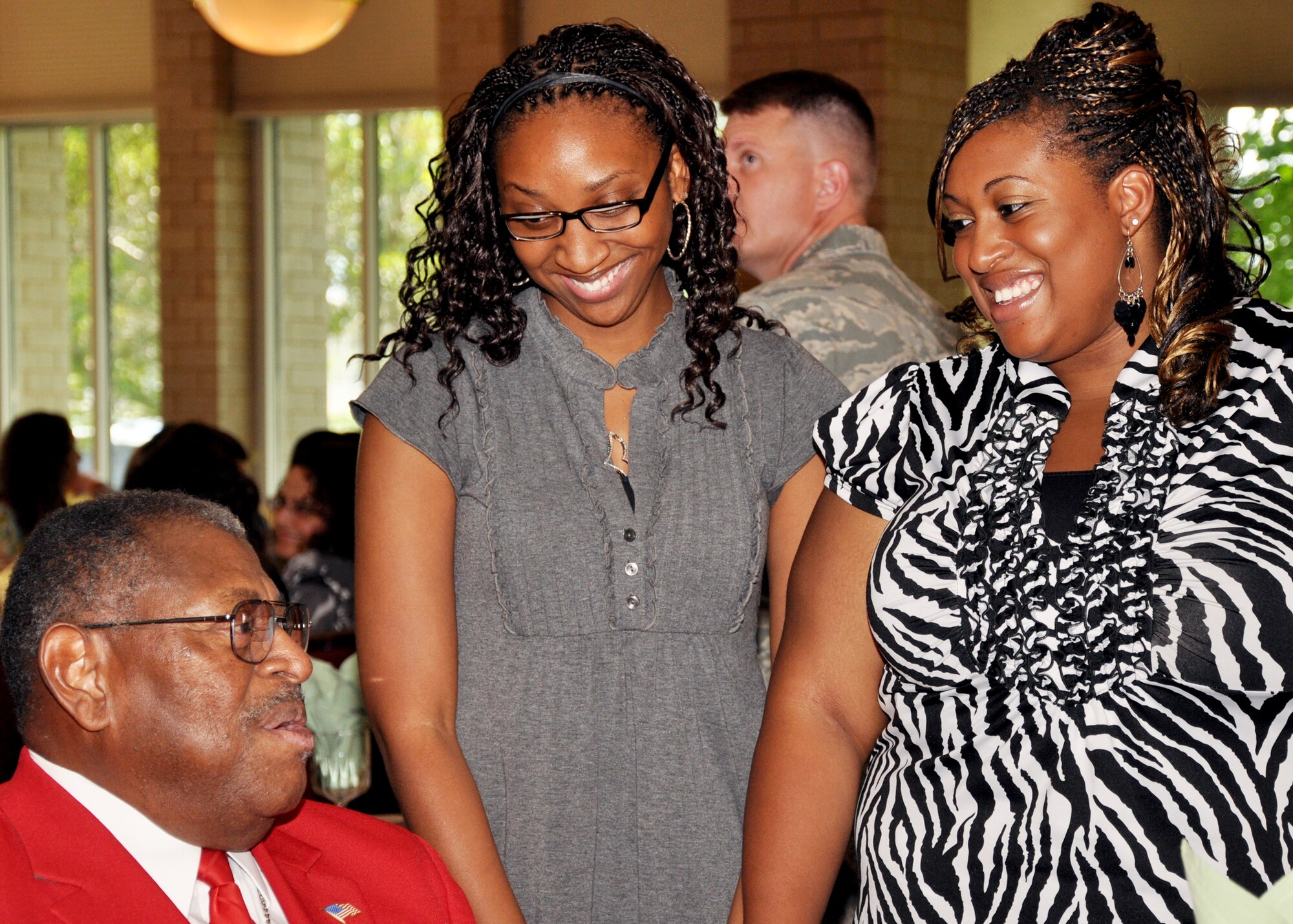 Nakisa Bradley and Miriam McGriff, Eglin summer hires, hear inspirational stories from retired chief master sergeant and recent congressional medal recipient, Walt Richardson, who was key-note speaker for this year's summer hire luncheon.  The 10-year old summer hire program had 121 summer hires this year.  (U.S. Air Force photo/Minty Knighton.)