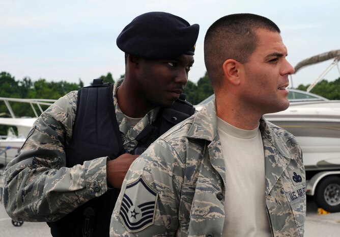 Senior Airman Nathaniel Williams handcuffs and searches Master Sgt. Sloan Kalina during a quality control exercise on Joint Base Charleston, S.C., July 28, 2010. The scenario given to Airman Williams consisted of an individual speeding past a gate checkpoint onto the base with a concealed weapon. Airman Williams was given a description of the vehicle and the general direction it was heading. In order to obtain his qualification, he had to locate the vehicle and provide a thorough search of the suspect inside. Airman Williams and Sergeant Kalina are both with the 628th Security Forces Squadron. (U.S. Air Force Photo/Airman 1st Class Lauren Main)