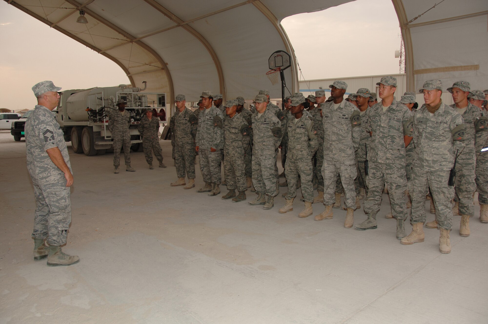 SOUTHWEST ASIA -- Senior Master Sgt. Steven Hampton, 379th Expeditionary Civil Engineer Escort Flight Superintendent, conducts roll call here August 3 before the escorts start their day. (U.S. Air Force photo/Tech. Sgt. Kimberly Spinner)