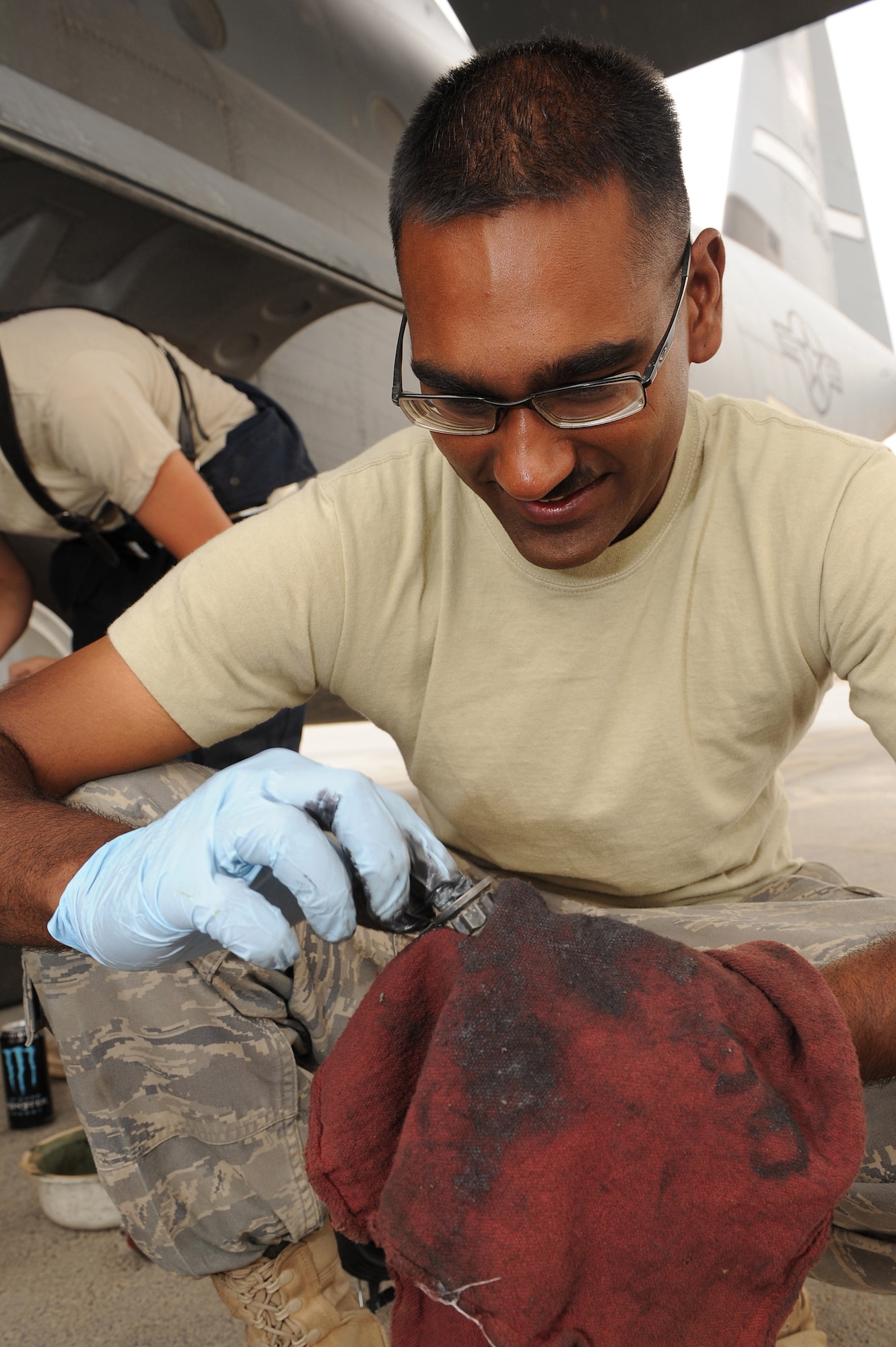 Staff Sgt. Riaaz Hosein, an aircraft hydraulic systems craftsman assigned to the 451st Expeditionary Aircraft Maintenance Squadron, Kandahar Airfield, Afghanistan, applies anti seize compound to the bolt of a C-130J Hercules brake assembly Aug. 2, 2010. Sergeant Hosein is currently deployed from Little Rock Air Force Base, Ark.   (U.S. Air Force photo by Tech. Sgt. Chad Chisholm/Released)