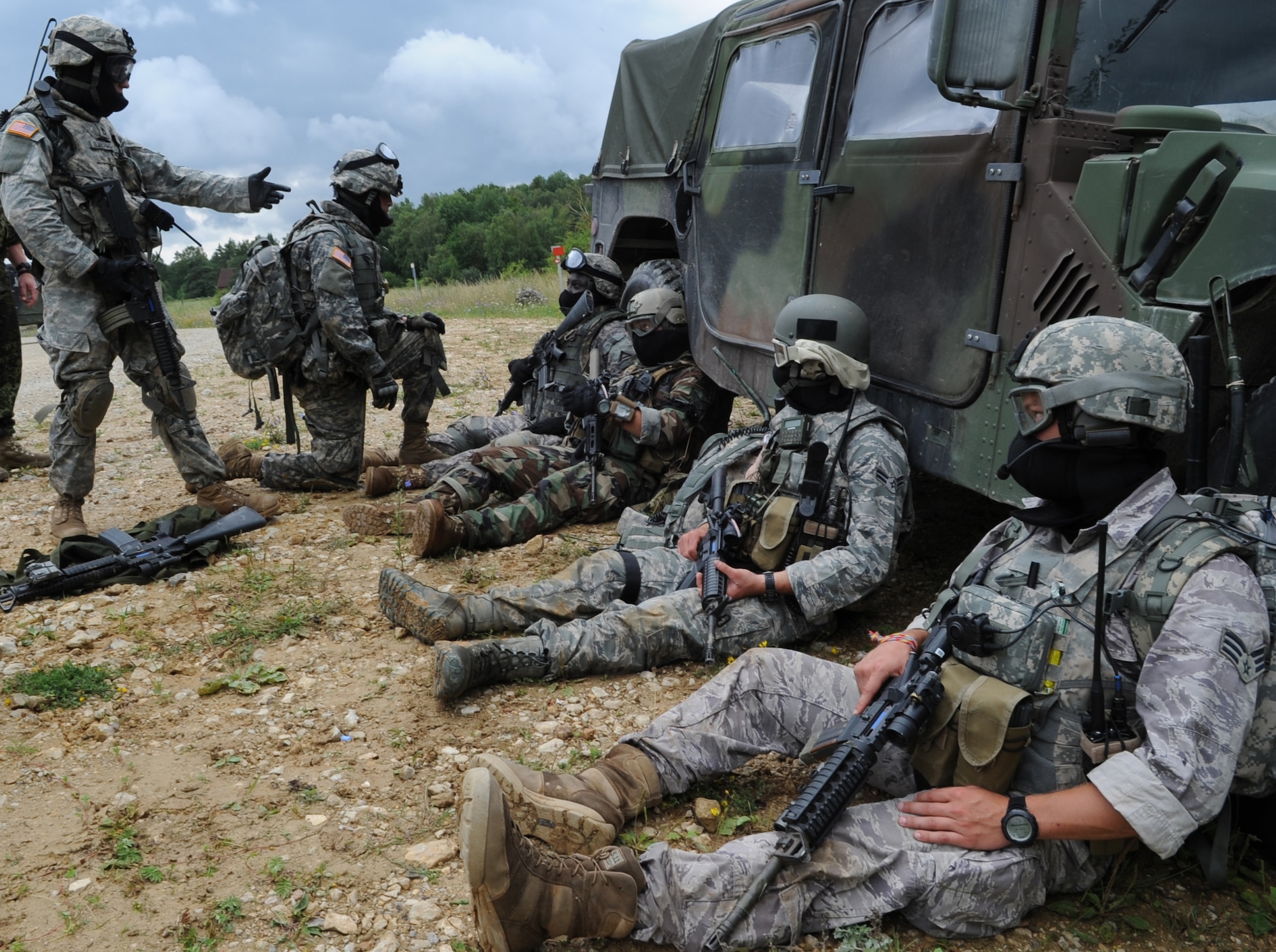 U.S. Air Force and Army members are treated for 'wounds' after an air assault mission scenario during exercise ALLIED STRIKE 10, Hohenfels, Germany, Aug. 3, 2010. AS 10 is Europe's premier close air support (CAS) exercise, held annually to conduct robust, realistic CAS training that helps build partnership capacity among allied North Atlantic Treaty Organization nations and joint services while refining the latest operational CAS tactics. For more ALLIED STRIKE information go to www.usafe.af.mil/alliedstrike.asp. (U.S. Air Force photo by Senior Airman Caleb Pierce)