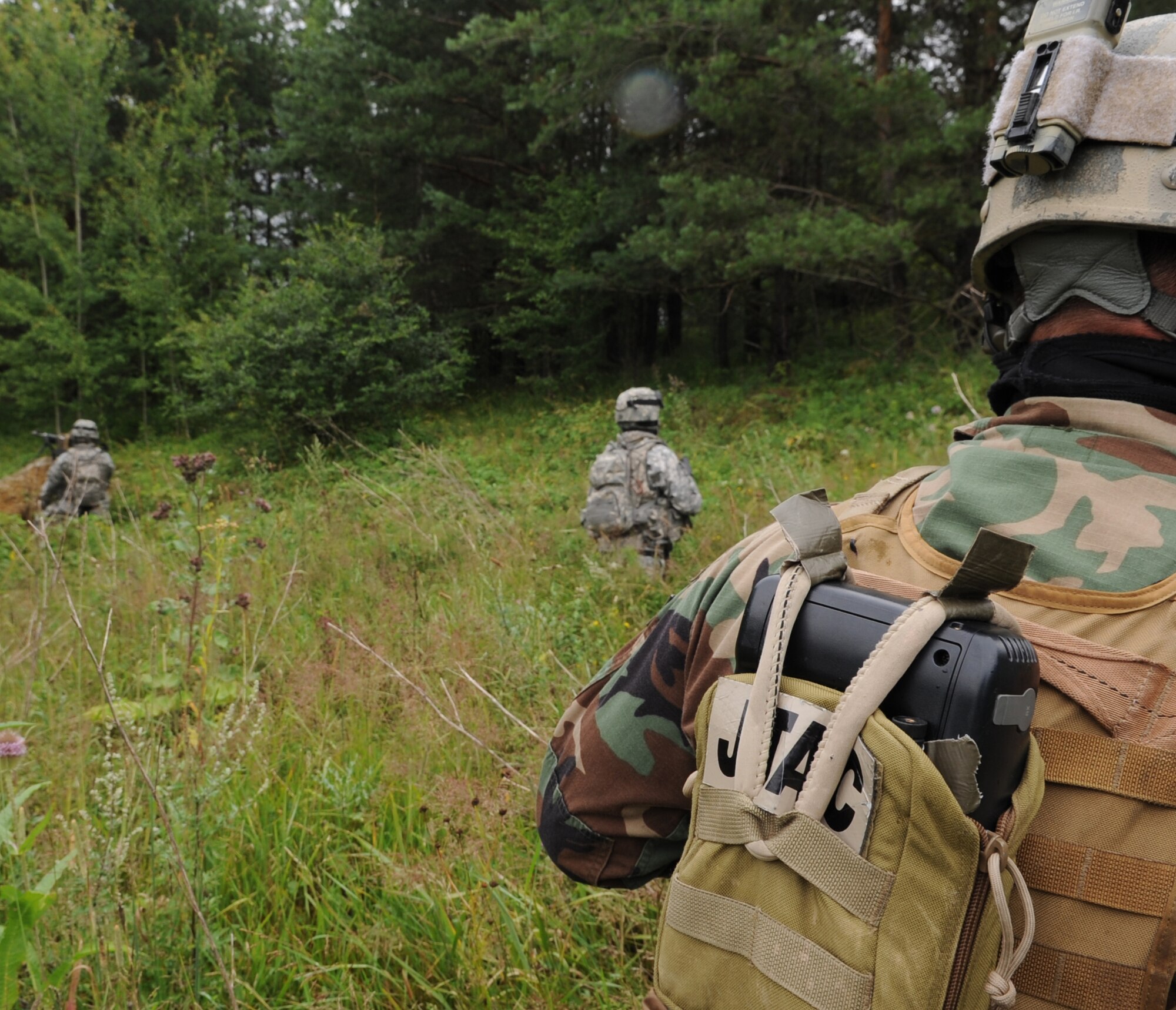 U.S. Air Force, Army and North Atlantic Treaty Organization's (NATO) members walk to set coordinates for an air assault mission scenario during exercise ALLIED STRIKE 10, Hohenfels, Germany, Aug. 3, 2010. AS 10 is Europe's premier close air support (CAS) exercise, held annually to conduct robust, realistic CAS training that helps build partnership capacity among allied North Atlantic Treaty Organization nations and joint services while refining the latest operational CAS tactics. For more ALLIED STRIKE information go to www.usafe.af.mil/alliedstrike.asp. (U.S. Air Force photo by Senior Airman Caleb Pierce)