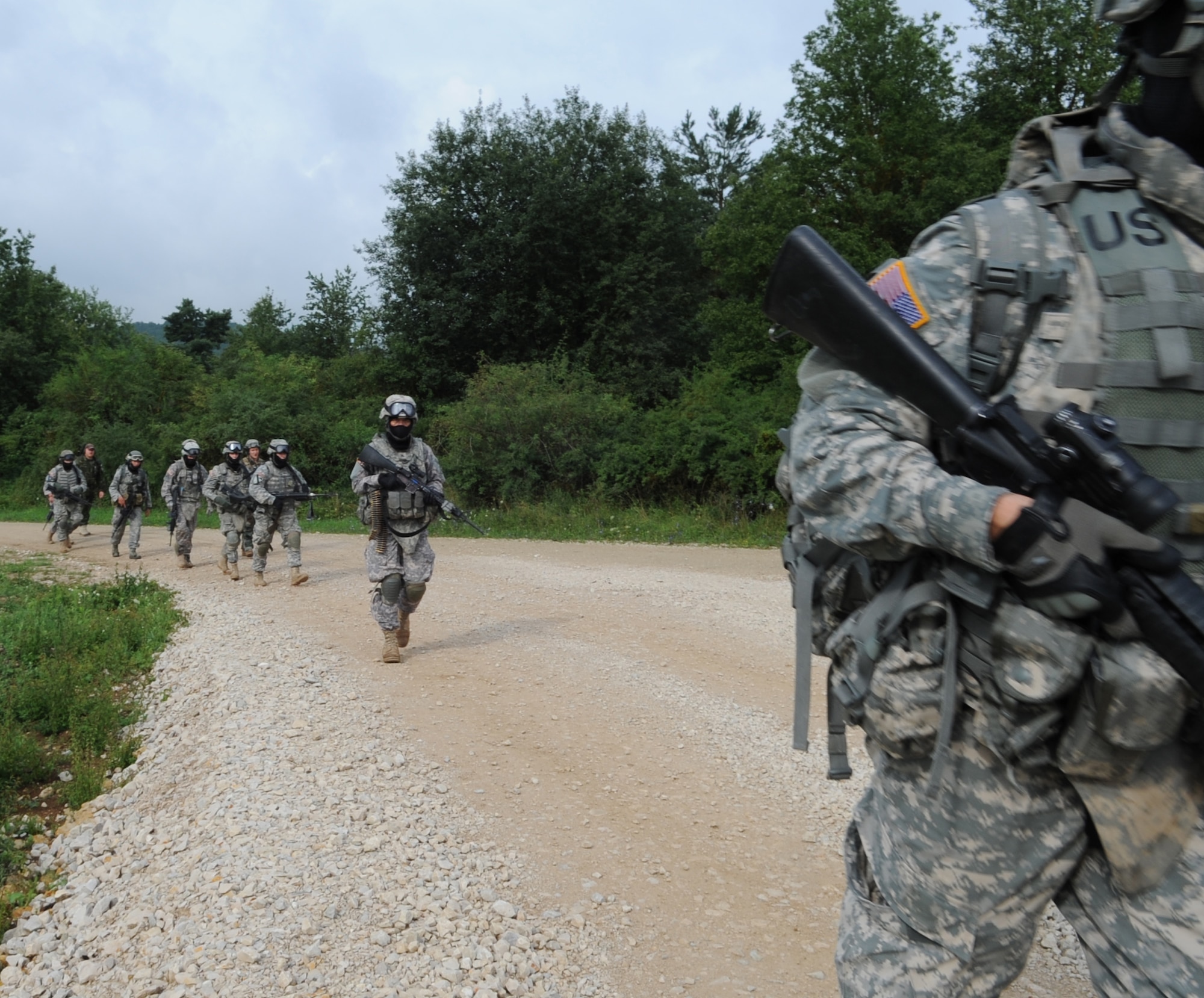 U.S. Air Force, Army and North Atlantic Treaty Organization's (NATO) members walk to the loading zone for an air assault mission scenario during exercise ALLIED STRIKE 10, Hohenfels, Germany, Aug. 3, 2010. AS 10 is Europe's premier close air support (CAS) exercise, held annually to conduct robust, realistic CAS training that helps build partnership capacity among allied NATO nations and joint services while refining the latest operational CAS tactics. For more ALLIED STRIKE information go to www.usafe.af.mil/alliedstrike.asp. (U.S. Air Force photo by Senior Airman Caleb Pierce)
