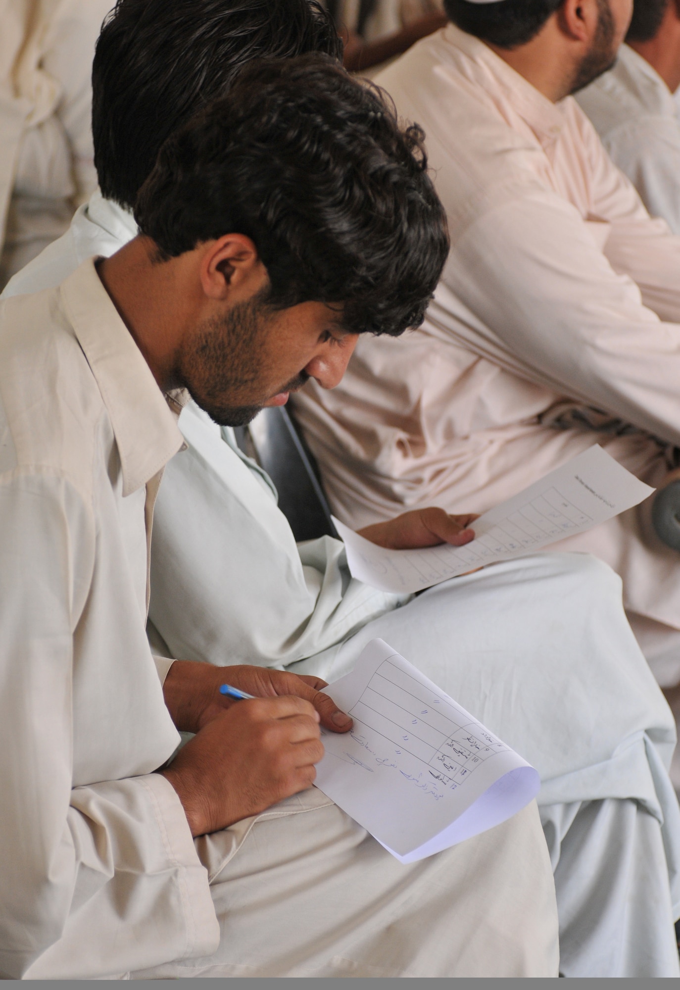 QALAT CITY, Afghanistan -- A local Afghan volleyball coach fills out a form to receive new equipment for his team during a sports meeting in Qalat City, Zabul Province, Aug. 1, 2010. The equipment was donated by the Zabul Provincial Governor and Provincial Reconstruction Team Zabul. The volleyball coaches received new volleyballs, shoes, uniforms and nets for the upcoming season. (U.S. Air Force photo/Senior Airman Nathanael Callon)