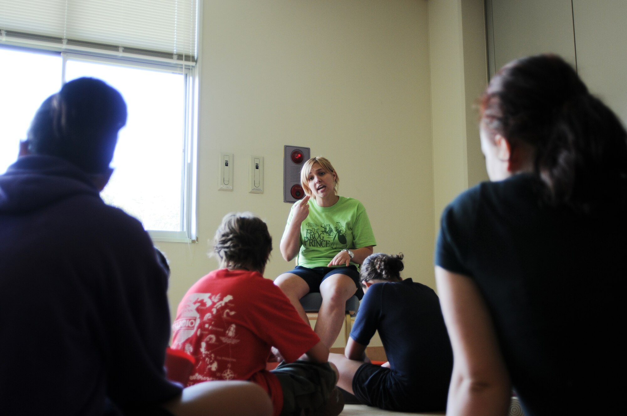 YOKOTA AIR BASE, Japan -- Emma Fyffe, Instructor with Missoula Children's Theatre, instructs the players of "The Frog Prince" as they learn the words to the final song in the play. Showtime for "The Frog Prince" is scheduled for 6 August, 1800 at the Taiyo Community Center. (U.S. Air Force Photo/ Airman 1st Class Katrina R. Menchaca)