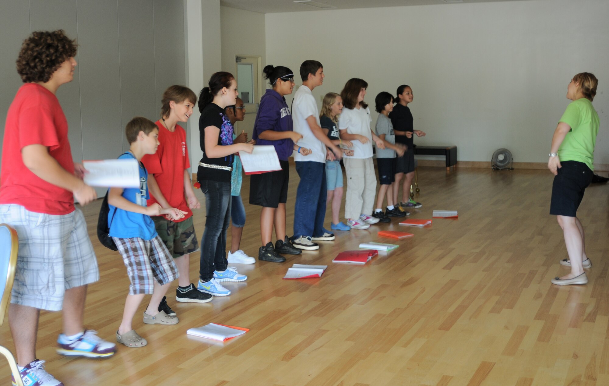 YOKOTA AIR BASE, Japan -- Emma Fyffe, Instructor with Missoula Children's Theatre, teaches the players from the production "The Frog Prince" the "shoop" dance move as they learn the final song in the play. Showtime for "The Frog Prince" is scheduled for 6 August, 1800 at the Taiyo Community Center. (U.S. Air Force Photo/ Airman 1st Class Katrina R. Menchaca) 