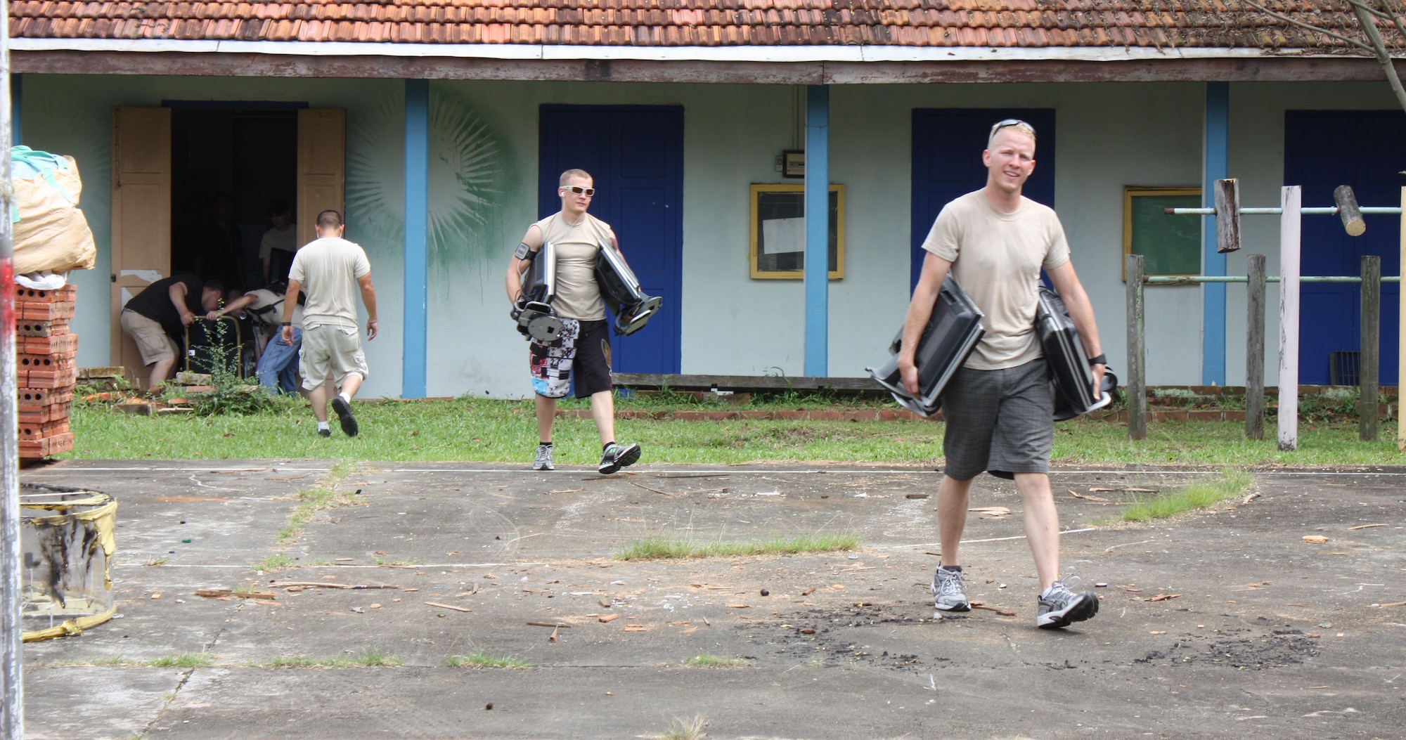 Airmen from Kadena move equipment at the ACMI training center in Singapore as part of a community service project during their time in the country for exercise Commando Sling. The Archdiocesan Commision  for the Pastoral Care of Migrants & Itinerant People, or ACMI, Training Center provides livelihood skills training to more than 200 students from various regional coutnries. (Courtesy photo)