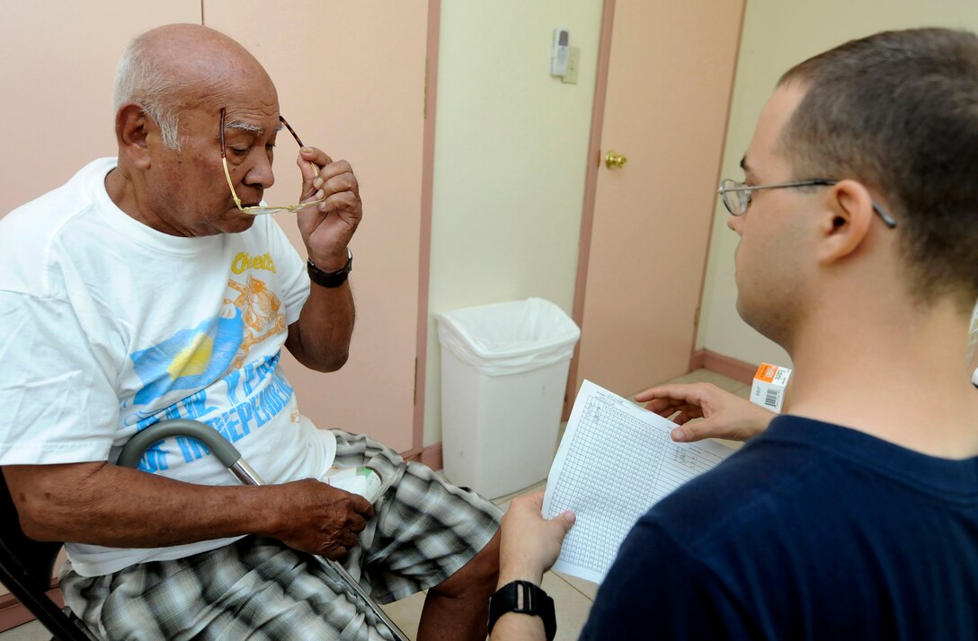 U.S. Navy Petty Officer 3rd Class Steven Nicholson, left, issues reading glasses to Hesus Belibei at the Angaur Medical Clinic in Angaur, Palau, July 29, 2010. Nicholson is assigned to the USS Blue Ridge.
