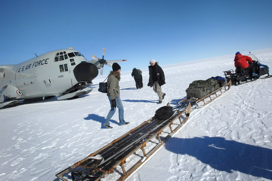 Scientists and others supporting the National Science Foundation research mission in Greenland stack their supplies on a waiting sled at the North Greenland Eemian ice drilling site, July 28, 2010. “NEEM” is an international ice core research project aimed at retrieving an ice core from northwestern Greenland.