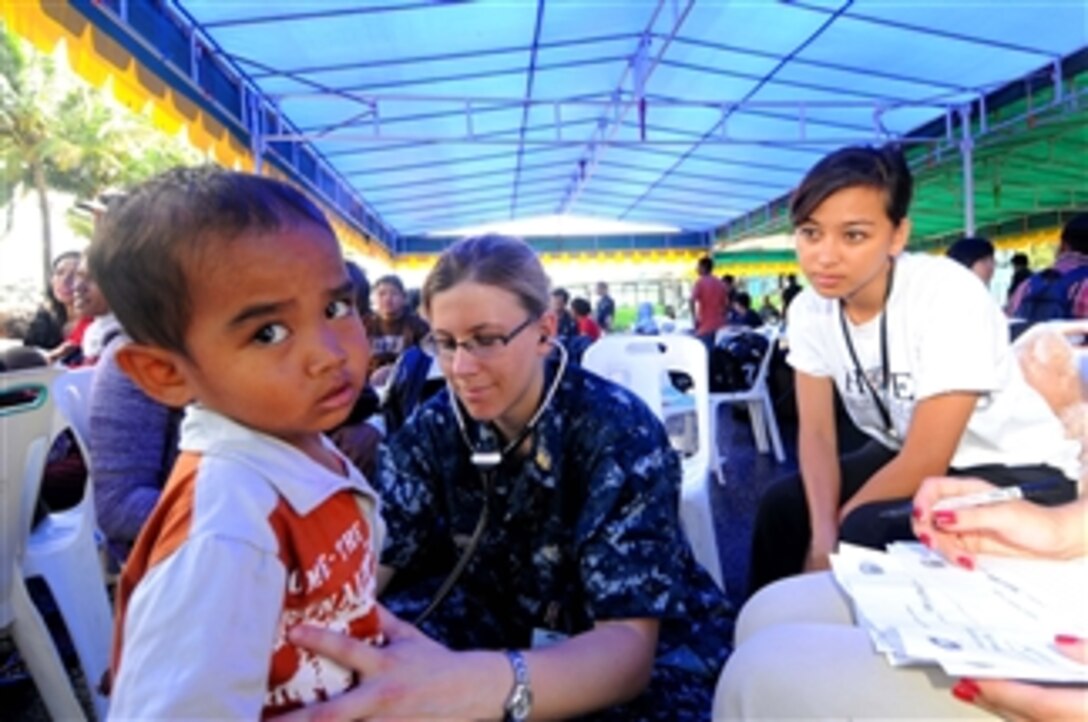 U.S. Navy Lt. Stacy Dodt, a doctor embarked aboard the Military Sealift Command hospital ship USNS Mercy (T-AH 19), examines an Indonesian child during a medical civic action program in Ambon, Indonesia, on July 27, 2010.  The Mercy is participating in Sail Banda 2010, a series of events hosted by Indonesia to promote the future of small islands.  The Mercy?s participation features medical and dental care clinics and construction projects in and around Ambon, as well as on Seram Island.  