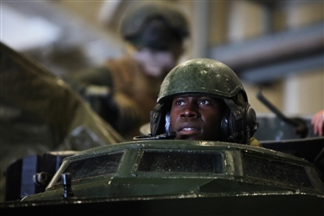 A U.S. Marine Corps corporal from the 4th Platoon, Charlie Company, 3rd Assault Amphibian Battalion, 1st Marine Division arrives at the amphibious transport dock ship USS New Orleans (LPD 18) after a large-scale multinational beach assault in Ancon, Peru, on July 18, 2010.  U.S. Marines were deployed in support of operation Partnership of the Americas/Southern Exchange, a combined amphibious exercise with maritime forces from Argentina, Mexico, Peru, Brazil, Uruguay and Colombia.  