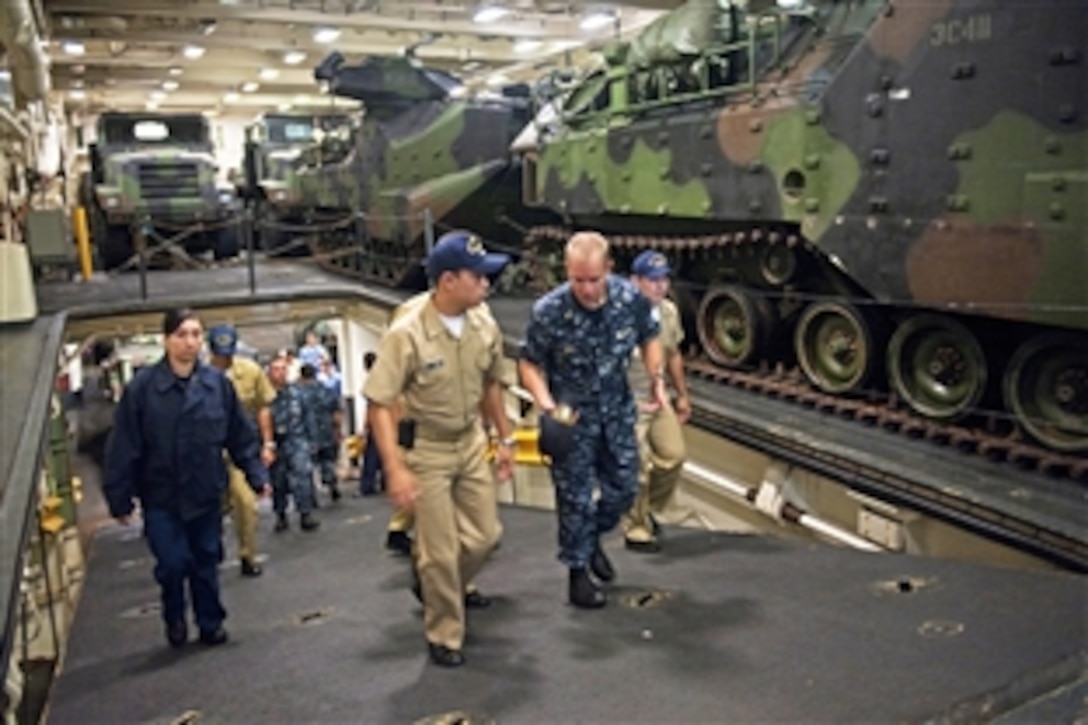 U.S. Navy Ensign Benjamin Hall, second from right, gives a tour of the amphibious transport dock ship USS New Orleans to sailors from the Colombian Navy at Bahia Malaga Naval Base, Colombia, Aug. 2, 2010. U.S. sailors and Marines participated in Amphibious-Southern Partnership Station 2010, a combined amphibious exercise designed to enhance cooperative partnerships with maritime forces from Argentina, Mexico, Peru, Brazil, Uruguay and Colombia. 