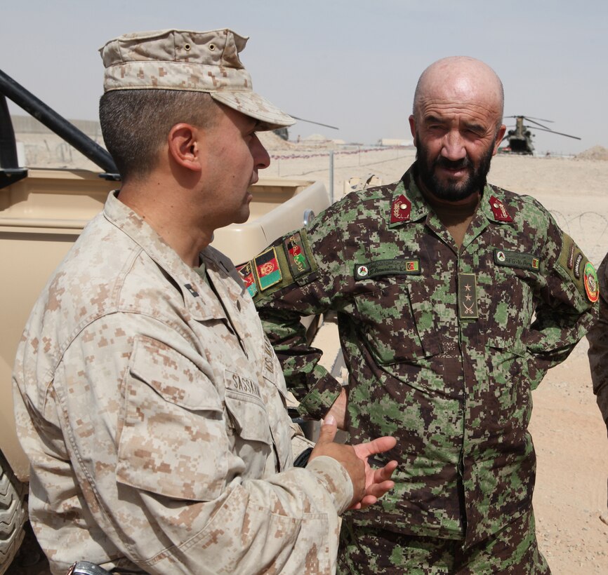 Capt. Oscar Sassarini, Embedded Partnering Team officer in charge, Combat Logistics Battalion 5, 1st Marine Logistics Group (Forward), discusses training with Lt. Col. Amanulla, 5th Kandak, 1st Brigade, 215th Corps commanding officer aboard Camp Bastion, Helmand Province, Afghanistan, August 4. The CLB-5 EPT trains and mentors soldiers of the Afghan National Army to provide logistical capabilities in support of the International Security Assistance Force.