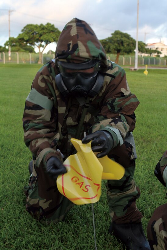 Lance Cpl. Max Diardio, telecommunications repairman with Communication Maintenance Division, Headquarters Battalion, 3rd Marine Division, III Marine Expeditionary Force, practices marking an area of chemical contamination during a Survey, Monitor and Decontamination course aboard Camp Courtney Aug. 5.