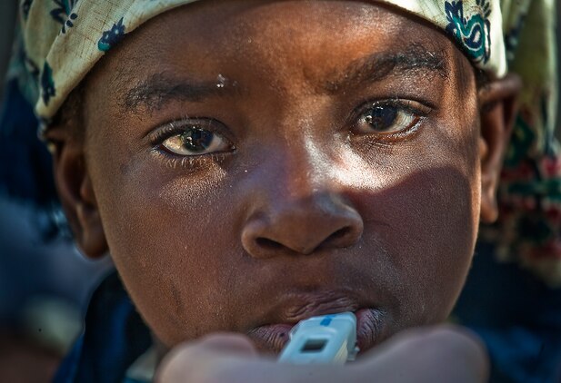 A Mozambican child has her temperature taken as she waits to be seen by U.S. military medical personnel during a medical engagement Aug. 5, 2010. Service members with Marine Forces Africa and Marine Forces Reserve set up medical clinics during exercise Shared Accord 2010, a 10-day exercise designed to build U.S. Africa Command partner nation capacity for peace and stability operations.