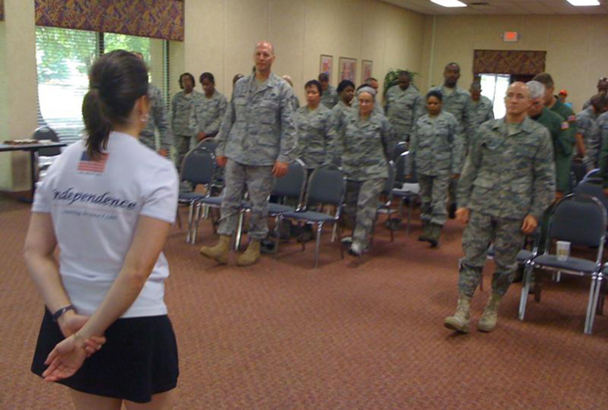 Karen Kaye, speed walking and running coach instructs the Dobbins Top 3 on building endurance, sticking to a good physical fitness program and buying running shoes that will best support your body at the Top 3 meeting July 11. (U.S. Air Force photo/Master Sgt. James Branch)