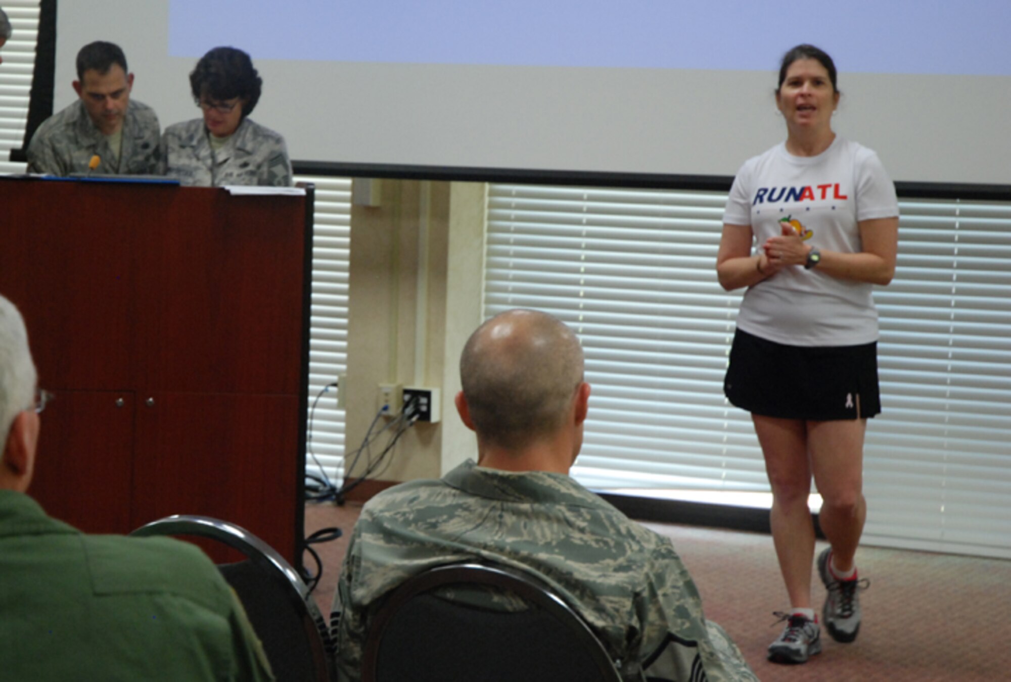 Karen Kaye, speed walking and running coach instructs the Dobbins Top 3 on building endurance, sticking to a good physical fitness program and buying running shoes that will best support your body at the Top 3 meeting July 11. (U.S. Air Force photo/Master Sgt. James Branch)