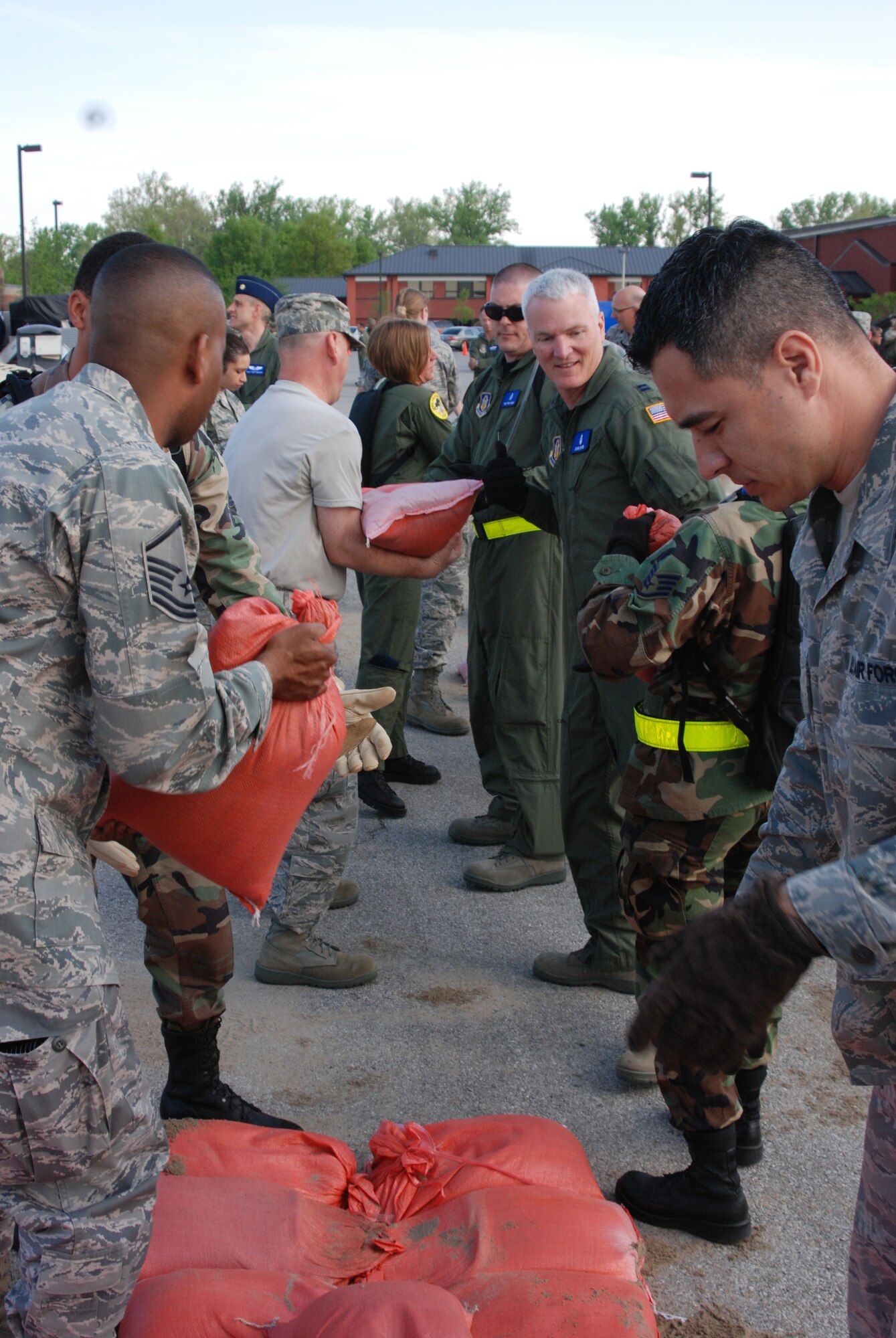 932nd Airlift Wing personnel pass sandbags down the line during a training weekend near Belleville, Ill.  They were preparing for a special Ability to Survive and Operate course at the Air Force Reserve Command wing.  (U.S. Air Force photo/Maj. Stan Paregien)