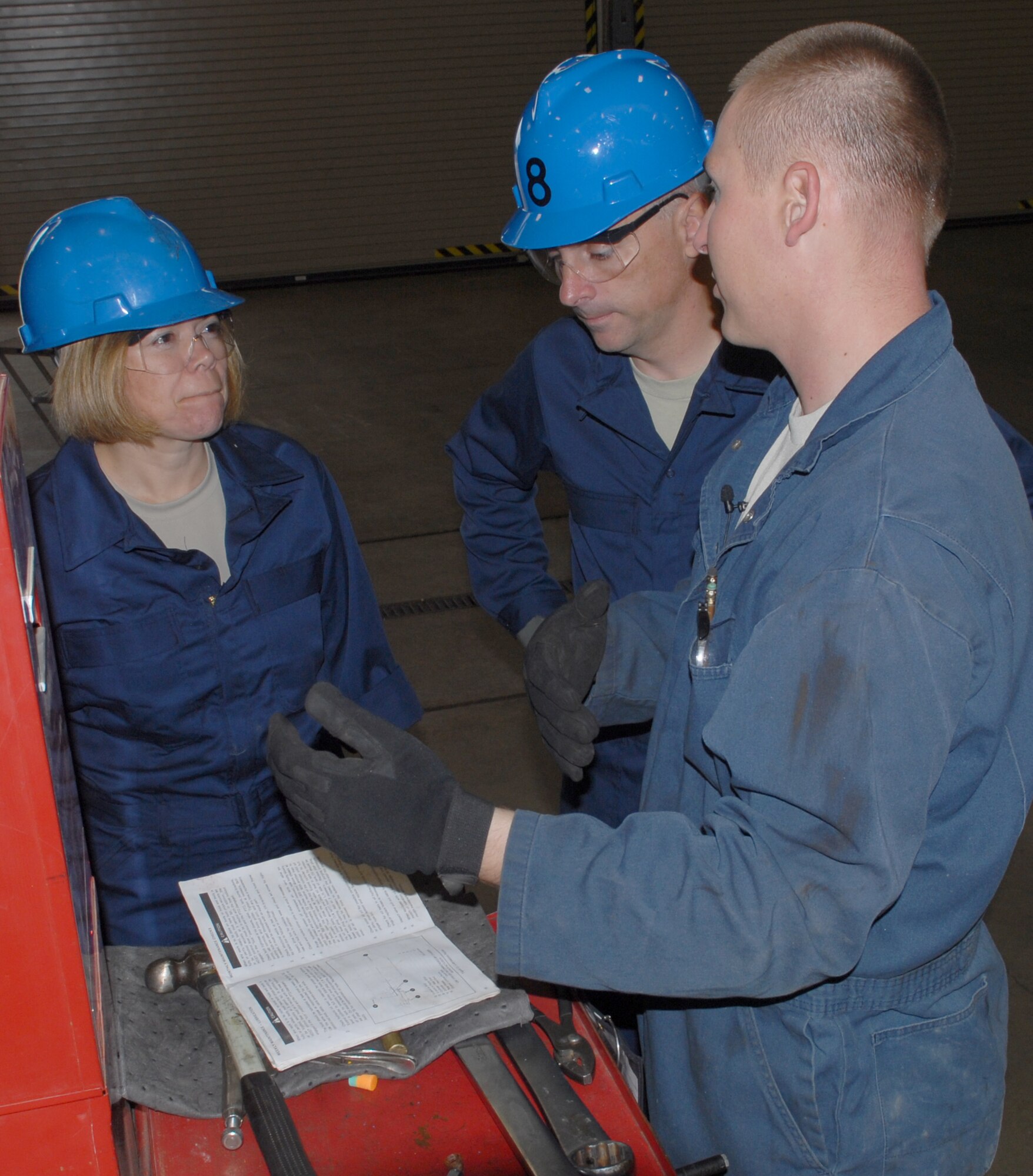 VANDENBERG AIR FORCE BASE, Calif.-- Staff Sgt. Brian Flynn, a 30th Logistic Readiness Squadron, vehicle and equipment technician, shares  standard operating procedures with Col. Richard Boltz, the 30th Space Wing commander and Chief Master Sgt. Angelica Johnson,  the 30th Space Wing command chief,  before working on a Sterling dump truck here Thursday,  Aug. 5, 2010. Colonel Boltz and Chief Johnson will be partaking monthly in activities within Team V's work centers. (U.S. Air Force photo/Senior Airman Antoinette Gibson)




