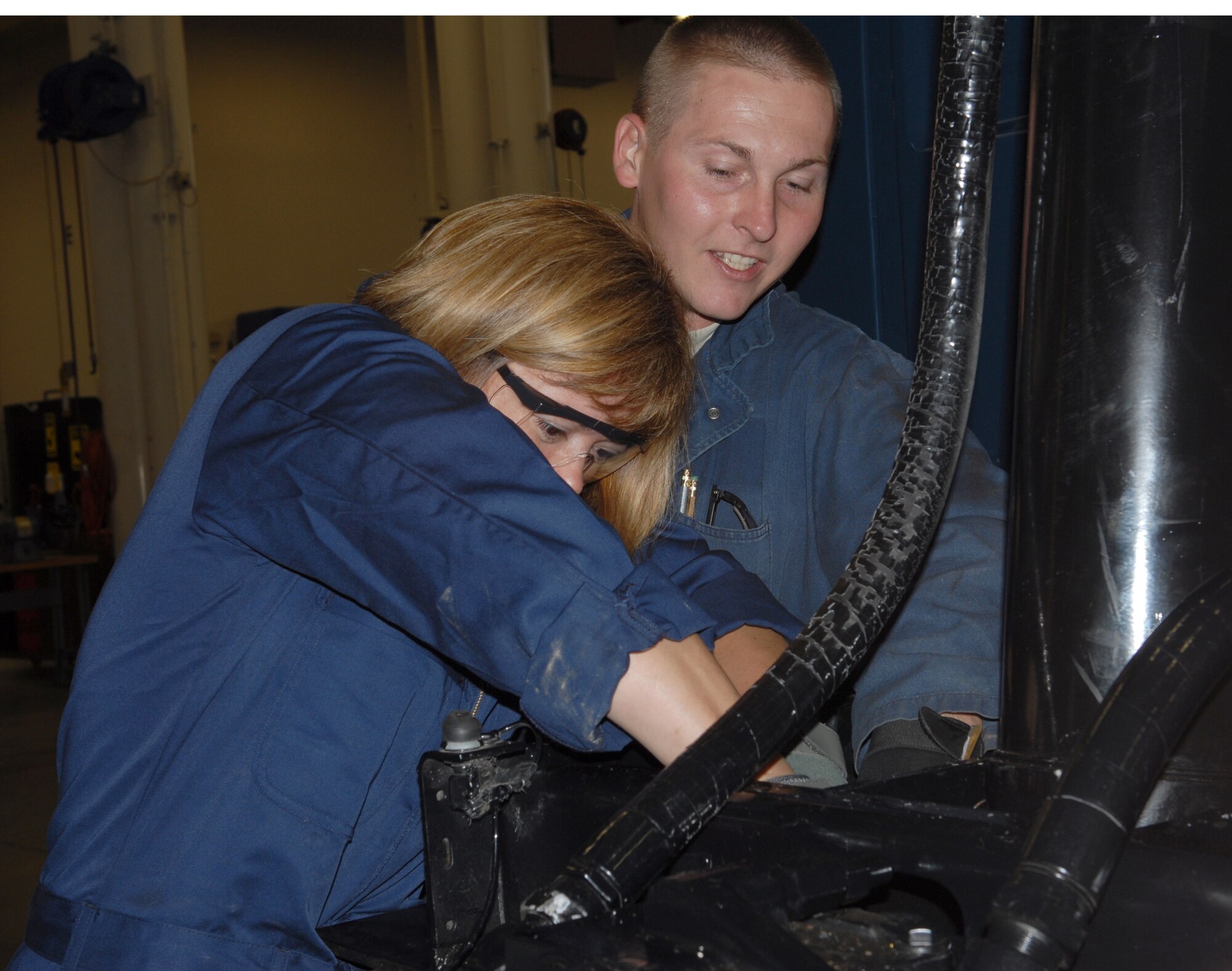 VANDENBERG AIR FORCE BASE, Calif.-- Chief Master Sgt. Angelica Johnson, the 30th Space Wing command chief assist Staff Sgt Brian Flynn, a 30th Logistic Readiness Squadron vehicle and equipment technician is tightening a bolt on a hydraulic cylinder here Thursday, Aug. 5, 2010. Colonel Boltz and Chief Johnson will be partaking monthly in activities within Team V's work centers. (U.S. Air Force photo/Senior Airman Antoinette Gibson)


