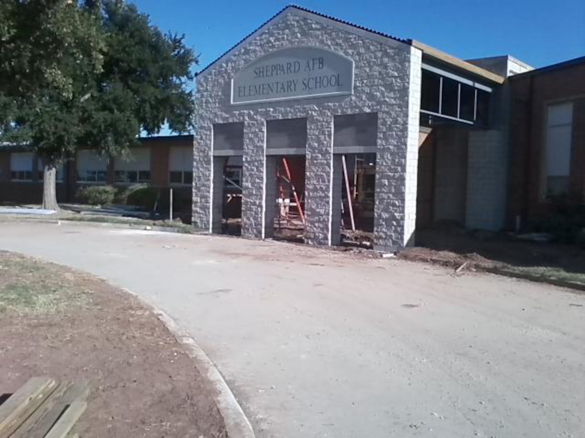 With a 2010 school year theme, 'A New Year, A New Look,' the elementary school at Sheppard Air Force Base, Texas, displays the new school name of Sheppard Air Force Base Elementary Aug 5.  The new facade is just part of the $1.5 million renovation the building received over the summer.  The new infrastructure, clinic, larger circle drive and entryway for Sheppard's elementary school are the result of the 2006 Wichita Falls School Bond election. (U.S. Air Force Photo courtesy/Marvin Peevey)