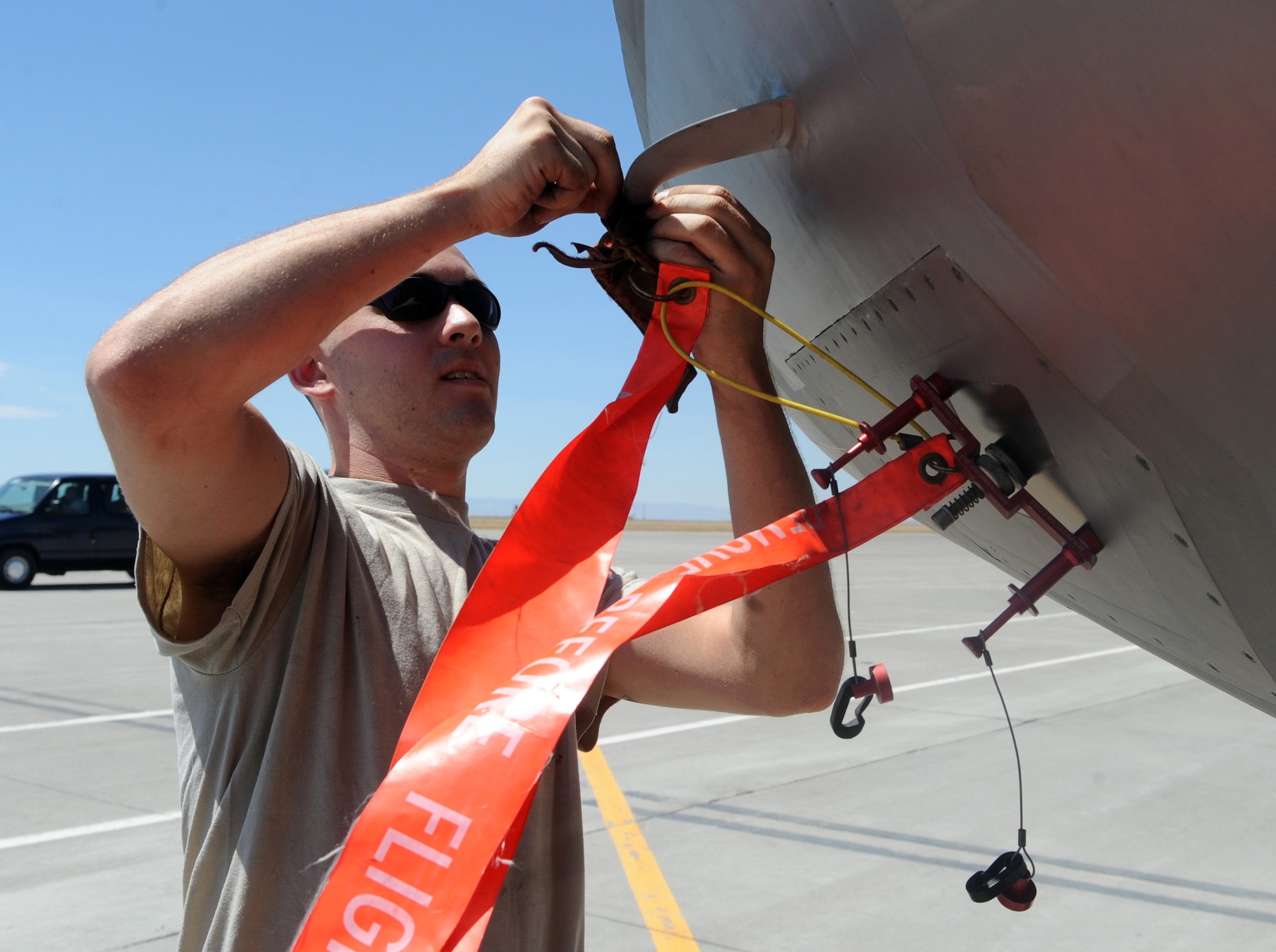 MOUNTAIN HOME AIR FORCE BASE, Idaho -- Senior Airman Joshua Schlichting, 43rd Aircraft Maintenance Unit crew chief from Tyndall Air Force Base, Fla., attaches a remove before flight ribbon to an F-22 Raptor after its landing July 29 here. More than 150 Airmen and 12 F-22 Raptors from the 43rd Fighter Squadron, arrived here in support of the Air Force’s first Operation Global Gem joint multi-service training. Global Gem is being conducted here from Aug. 2 to Sept. 2 and is primarily focused on conducting F-22 Raptor training missions with Marine F-5s and Air Force F-15Es. (U.S. Air Force photo by Airman 1st Class Debbie Lockhart)